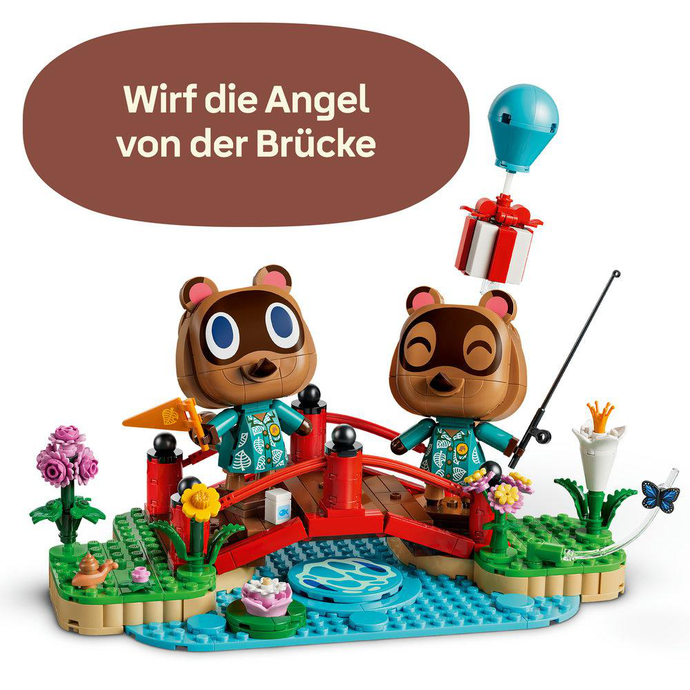 Lego Animal Crossing Set mit zwei Waschbären Figuren auf einer roten Brücke über einem blauen Fluss.