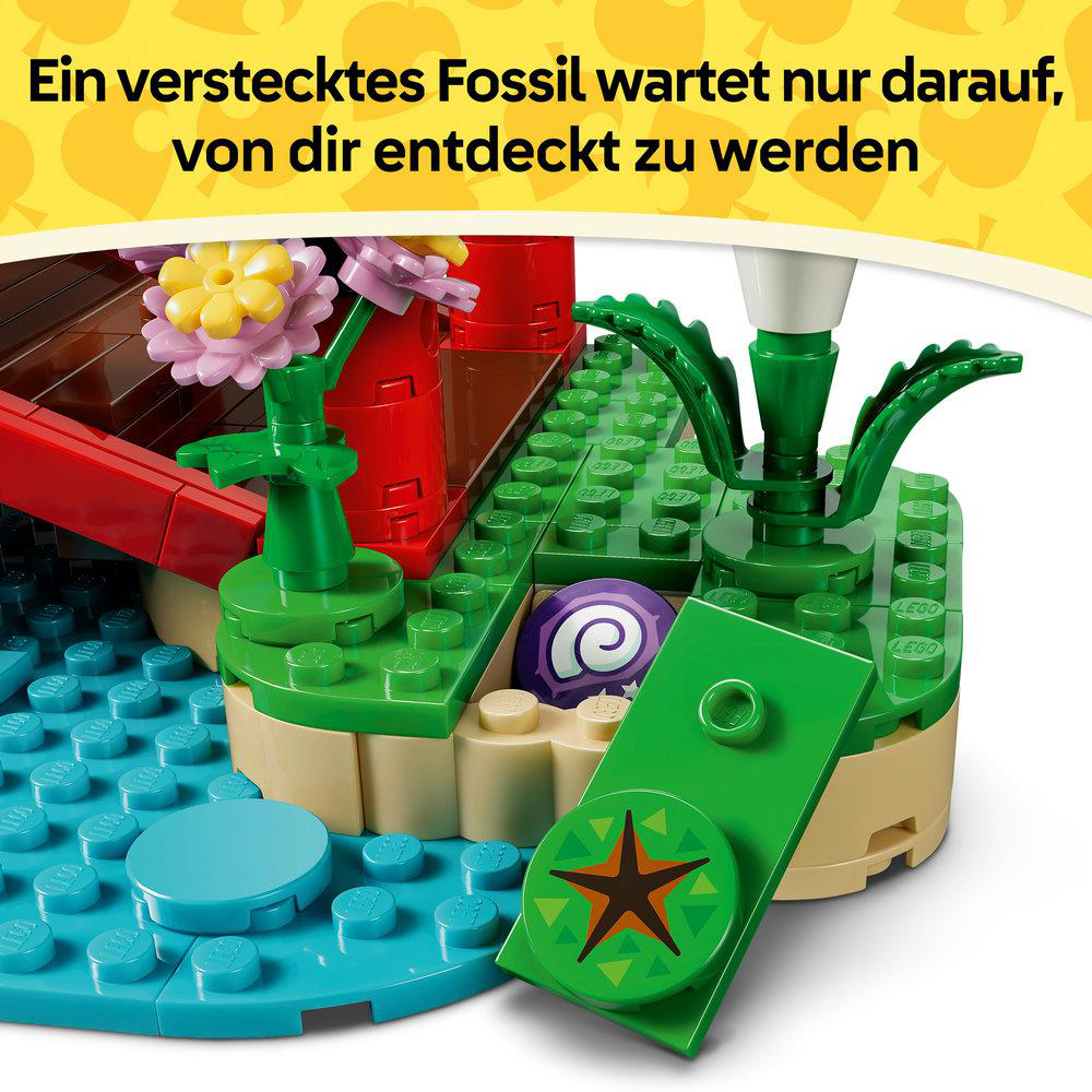 Ein Lego-Modell mit Blumen, einer roten Brücke und blauen Platten, die Wasser darstellen.