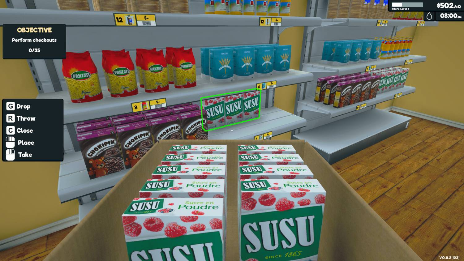 Una caja de comestibles dentro de un supermercado, con estantes de varios productos visibles al fondo.