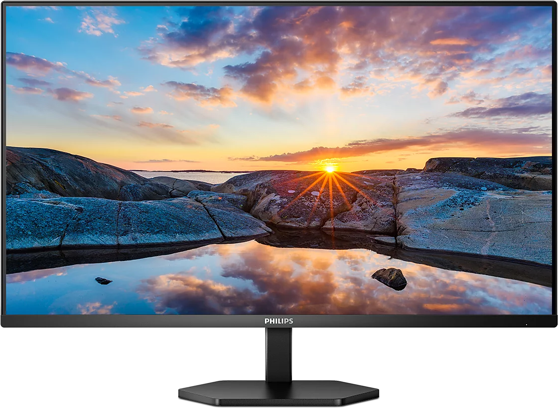 Egy Philips monitor naplementét mutat egy sziklás part és víz felett.