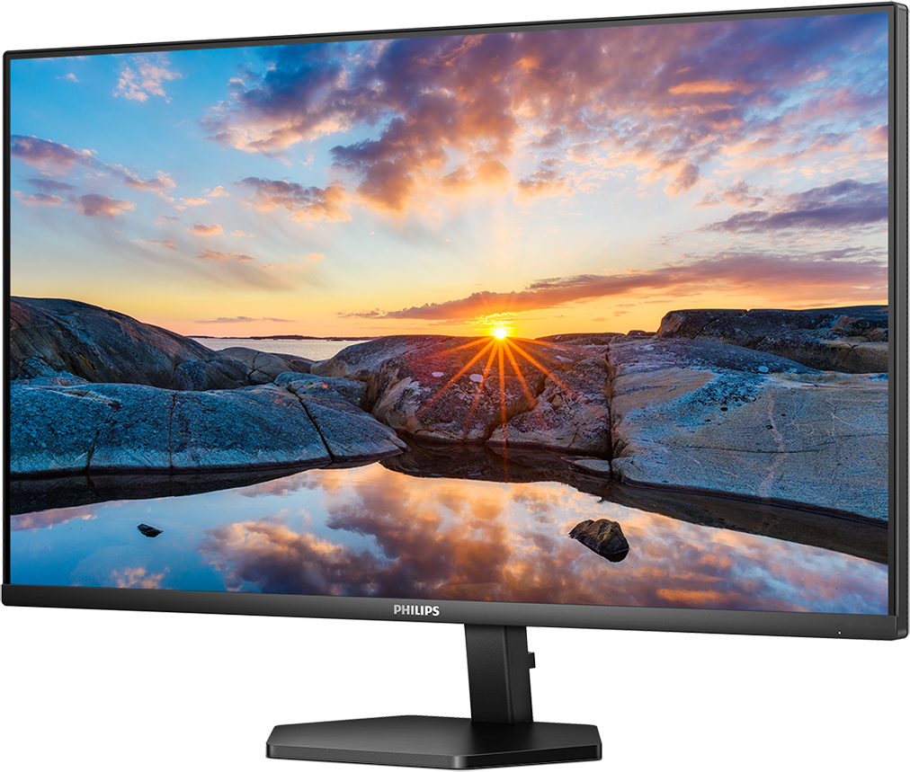 Egy Philips monitor festői naplementét mutat egy sziklás part és víz felett.