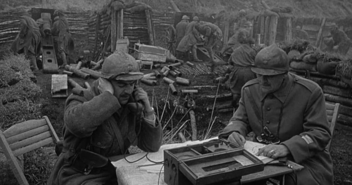 Soldaten in einem schlammigen Schützengraben bedienen Feldtelefone und Karten inmitten von Militärausrüstung.
