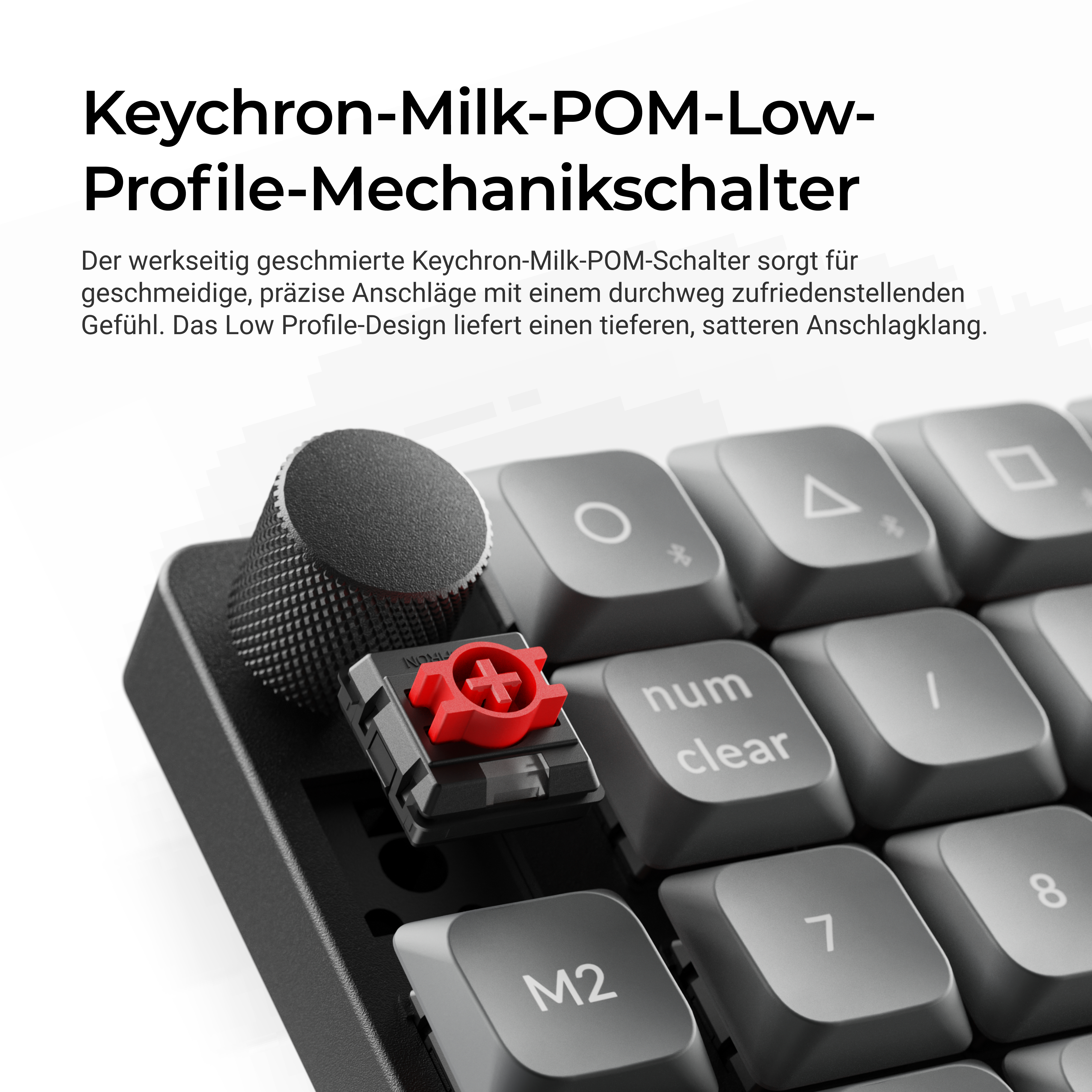 Nahaufnahme einer mechanischen Tastatur mit einem roten Schalter, einem Drehregler und grauem Text.