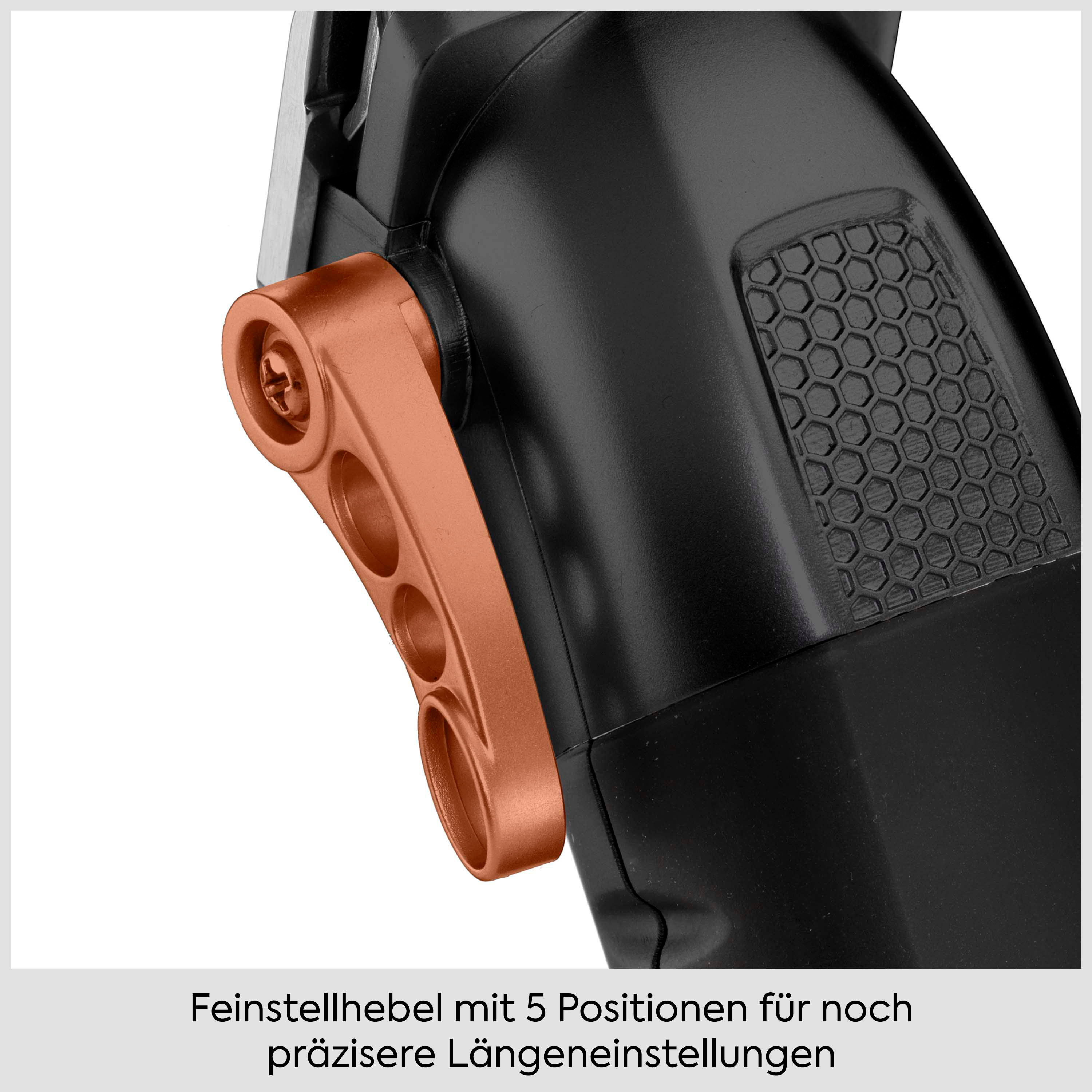 Nahaufnahme eines schwarzen Haarschneiders mit kupferfarbenem Hebel für die Längeneinstellung.