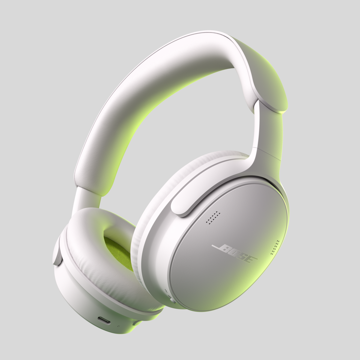Casque supra-auriculaire Bose blanc avec éclairage intérieur jaune sur fond gris.