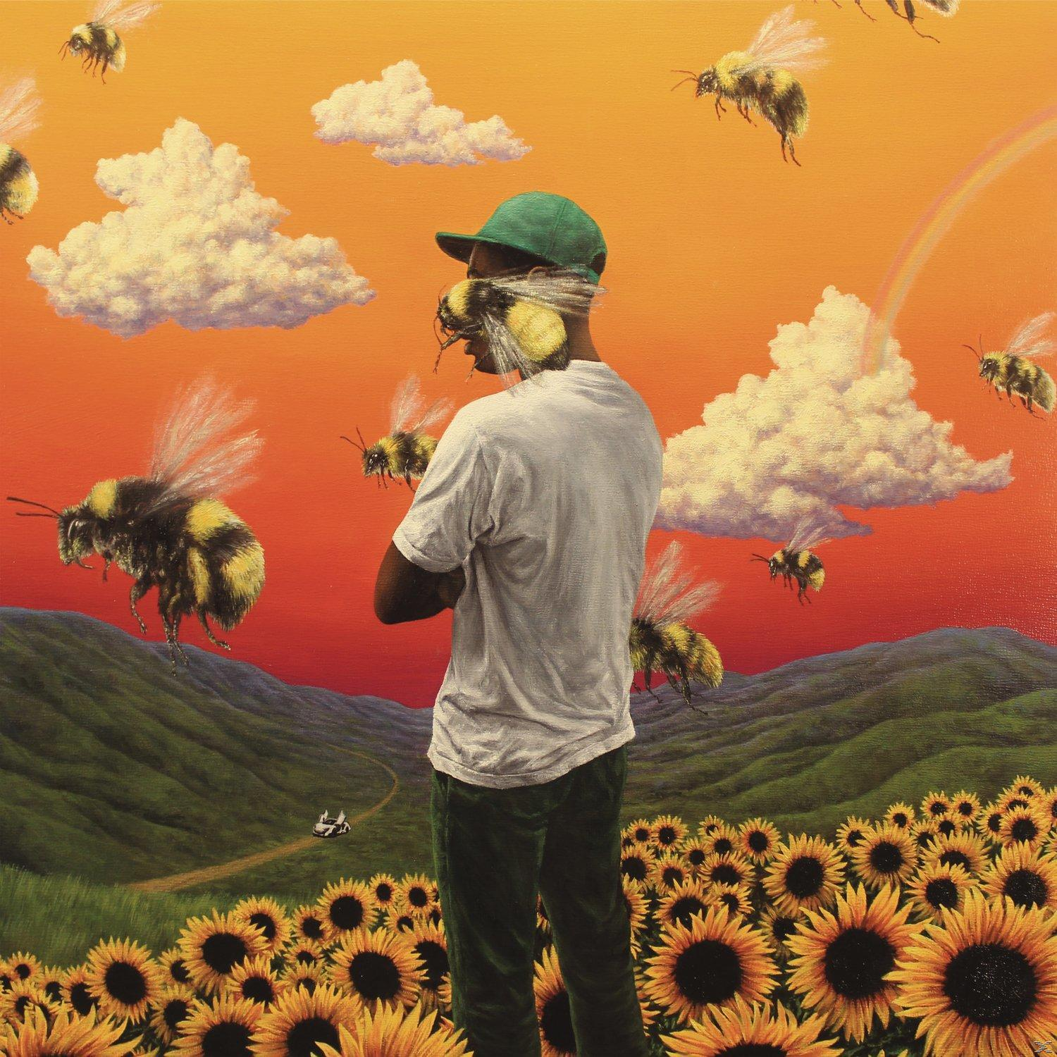 Une personne en chemise blanche et casquette verte dans un champ de tournesols, entourée d'abeilles géantes.