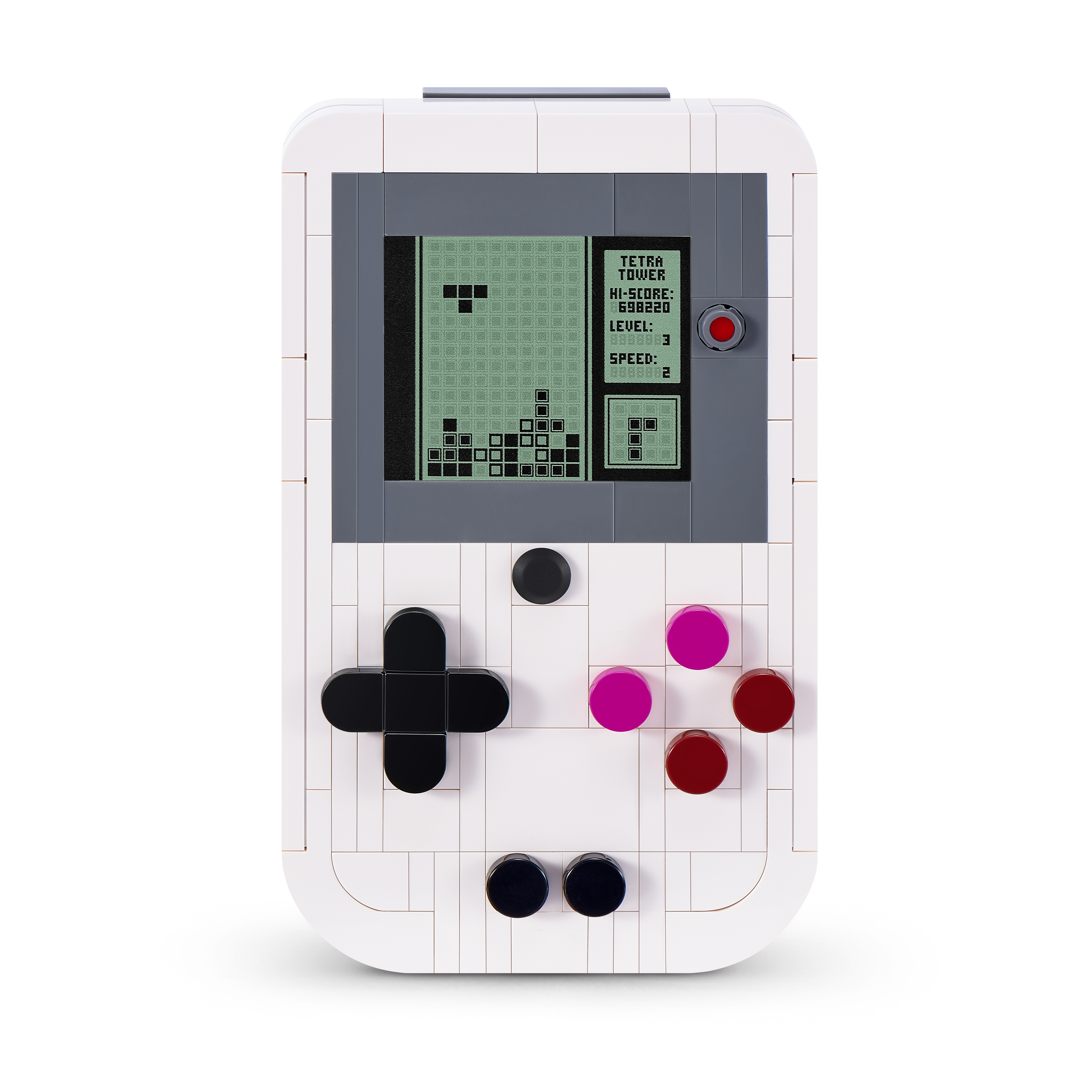 Una consola de juegos retro blanca hecha de bloques con una pantalla que muestra Tetris y botones coloridos.