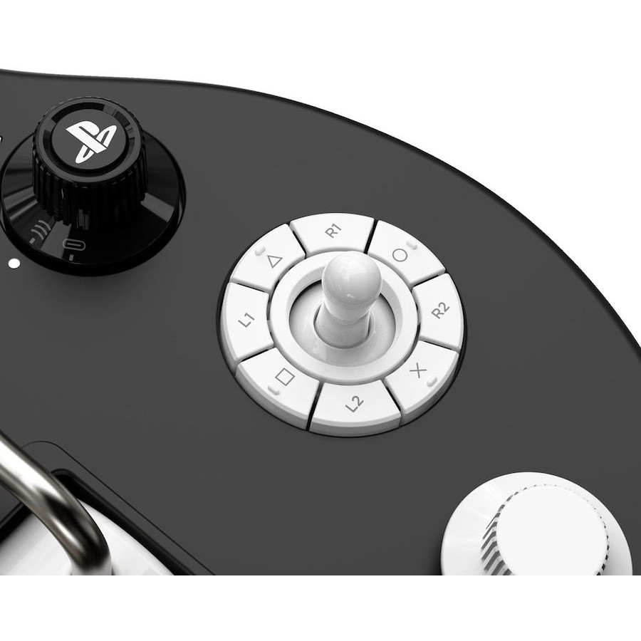 Primer plano de un controlador de accesibilidad de PlayStation negro con botones blancos y joystick.