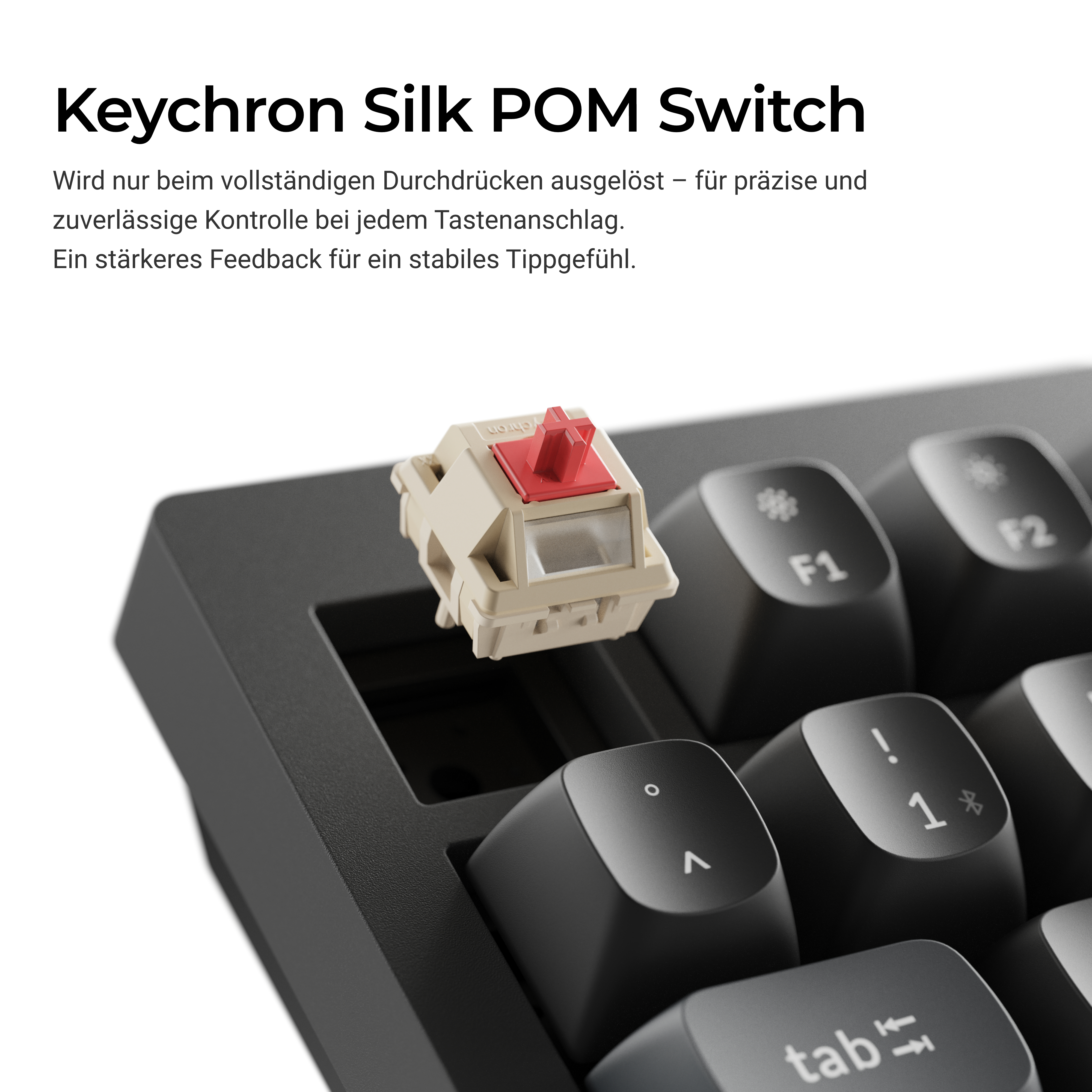Ein Keychron Silk POM-Schalter schwebt über einer schwarzen Tastatur mit weißer Beschriftung.