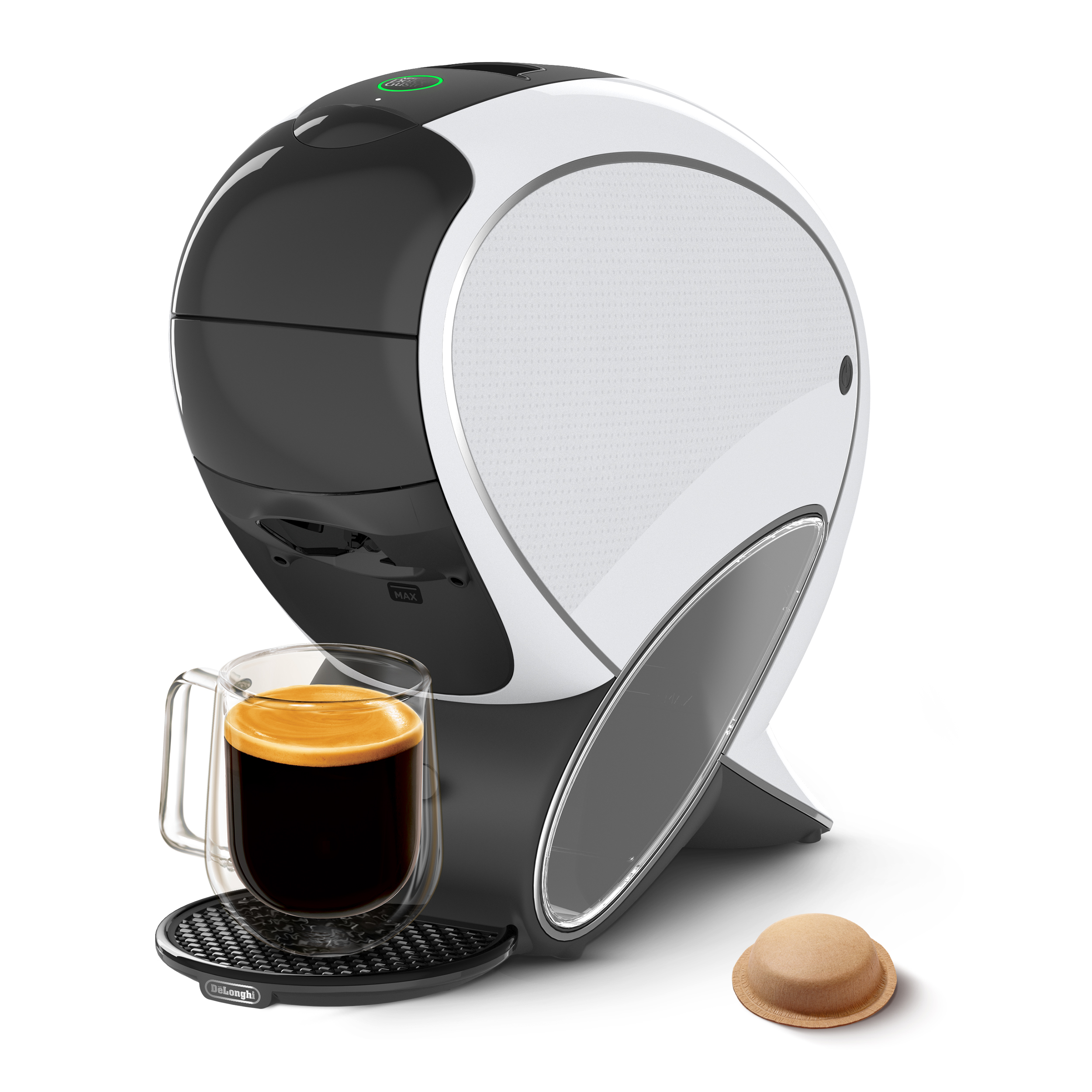 Moderna cafetera blanca y negra con taza de vidrio con café y una cápsula de café al lado sobre fondo blanco.