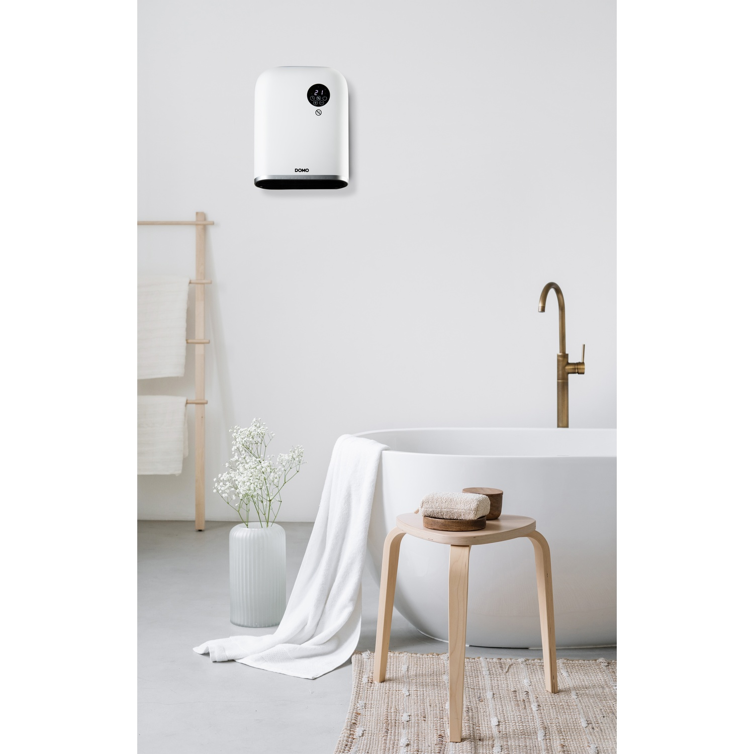 A modern bathroom features a white bathtub, a wall-mounted heater, a wooden stool, and a towel on a rug.