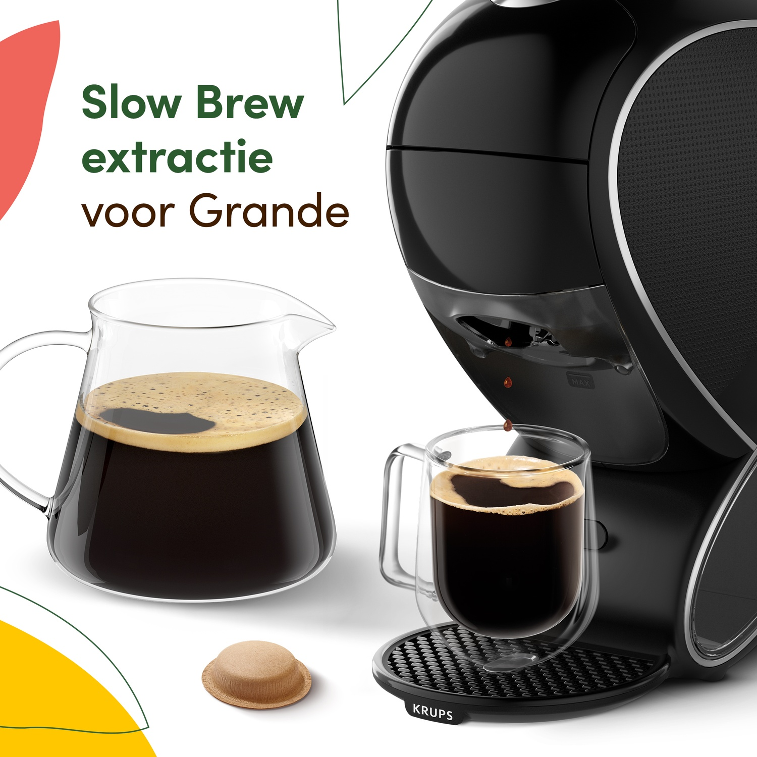 Black Krups coffee maker filling a cup and a carafe with coffee, with a coffee pod nearby.