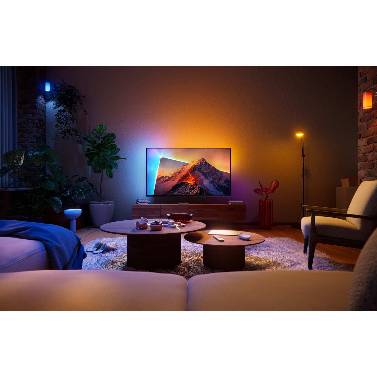 Cozy living room with an illuminated TV showing a mountain landscape, plants, and wooden furniture.