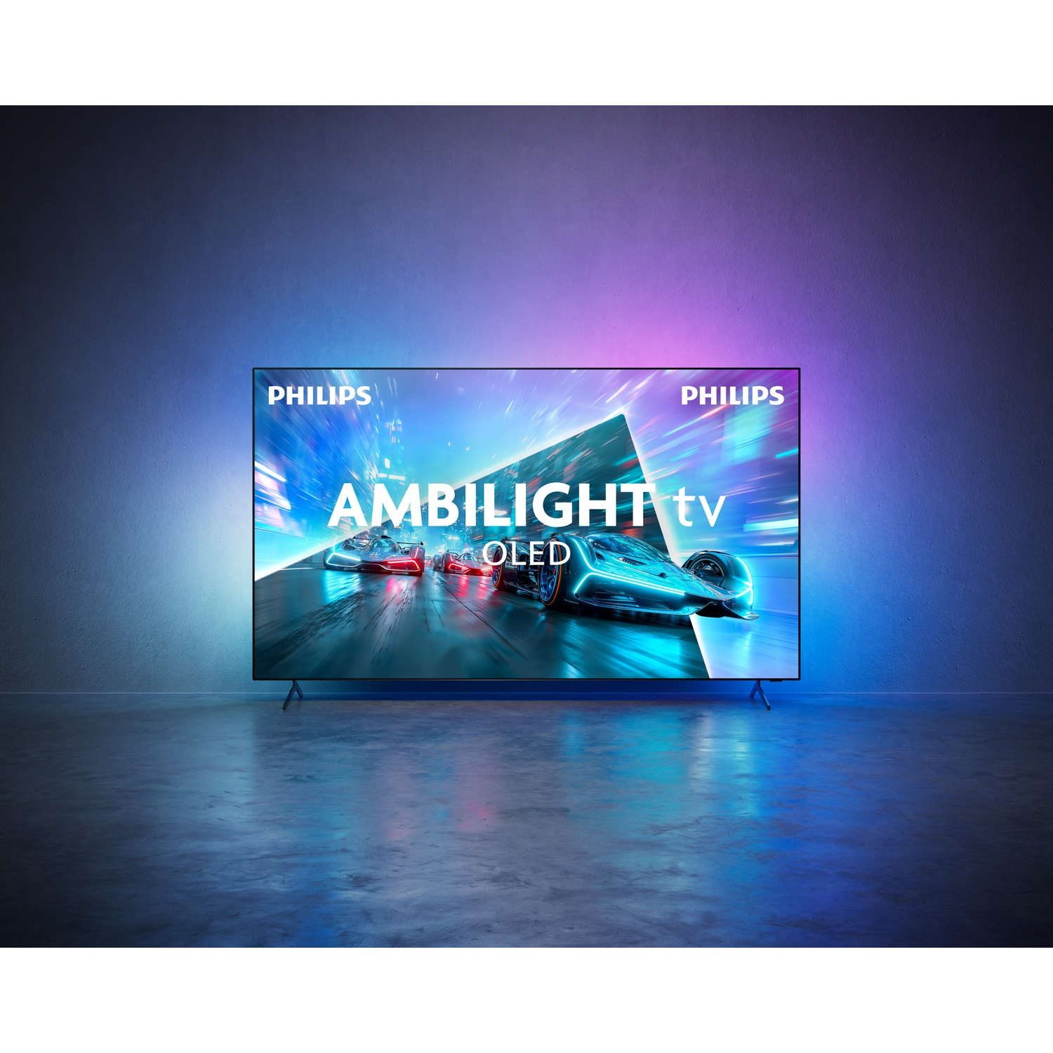 A Philips Ambilight OLED TV stands on the floor, casting colorful light onto the wall, displaying racing cars.
