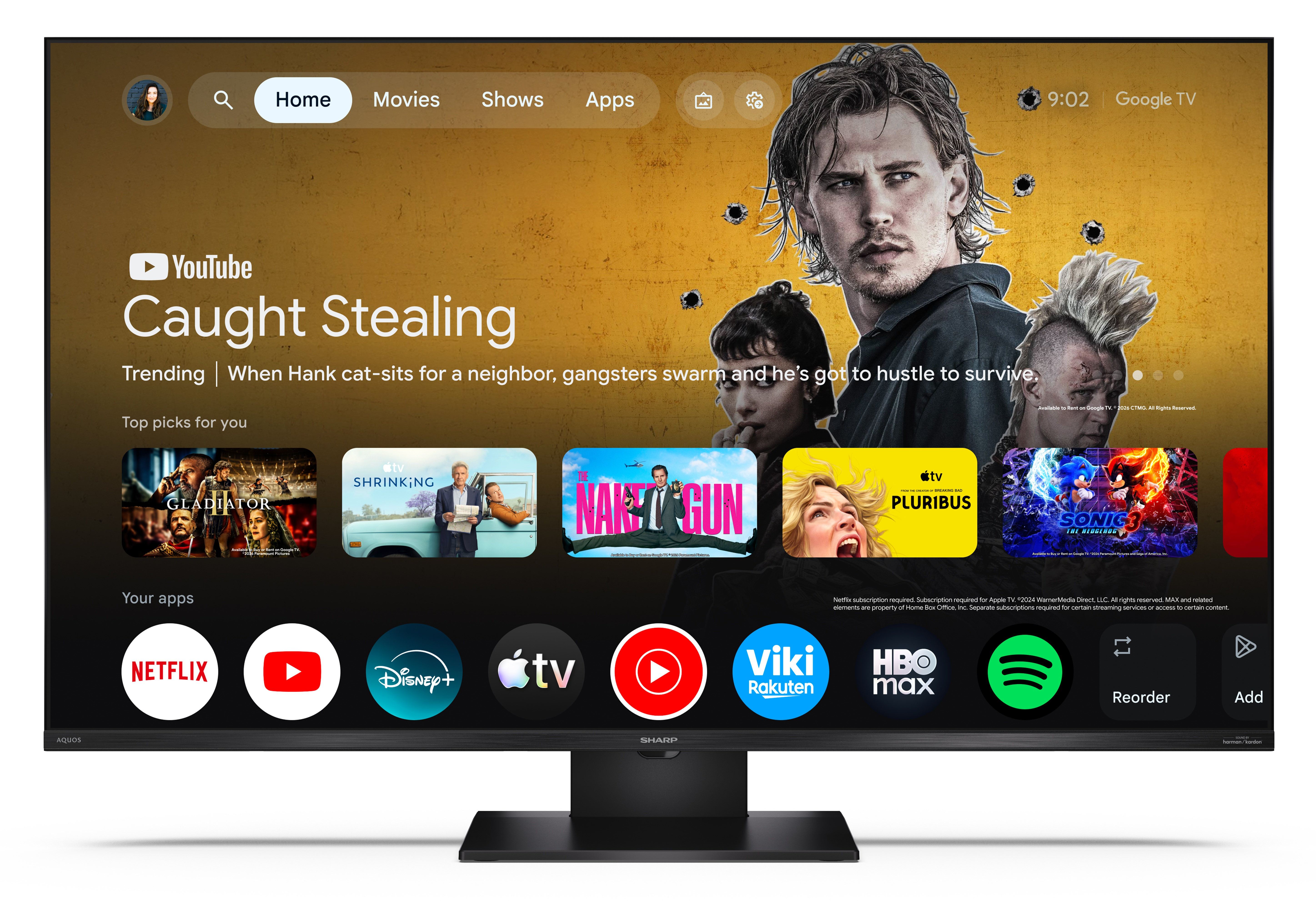 Ekran główny Google TV z polecanymi filmami, takimi jak Caught Stealing, oraz ikonami aplikacji.