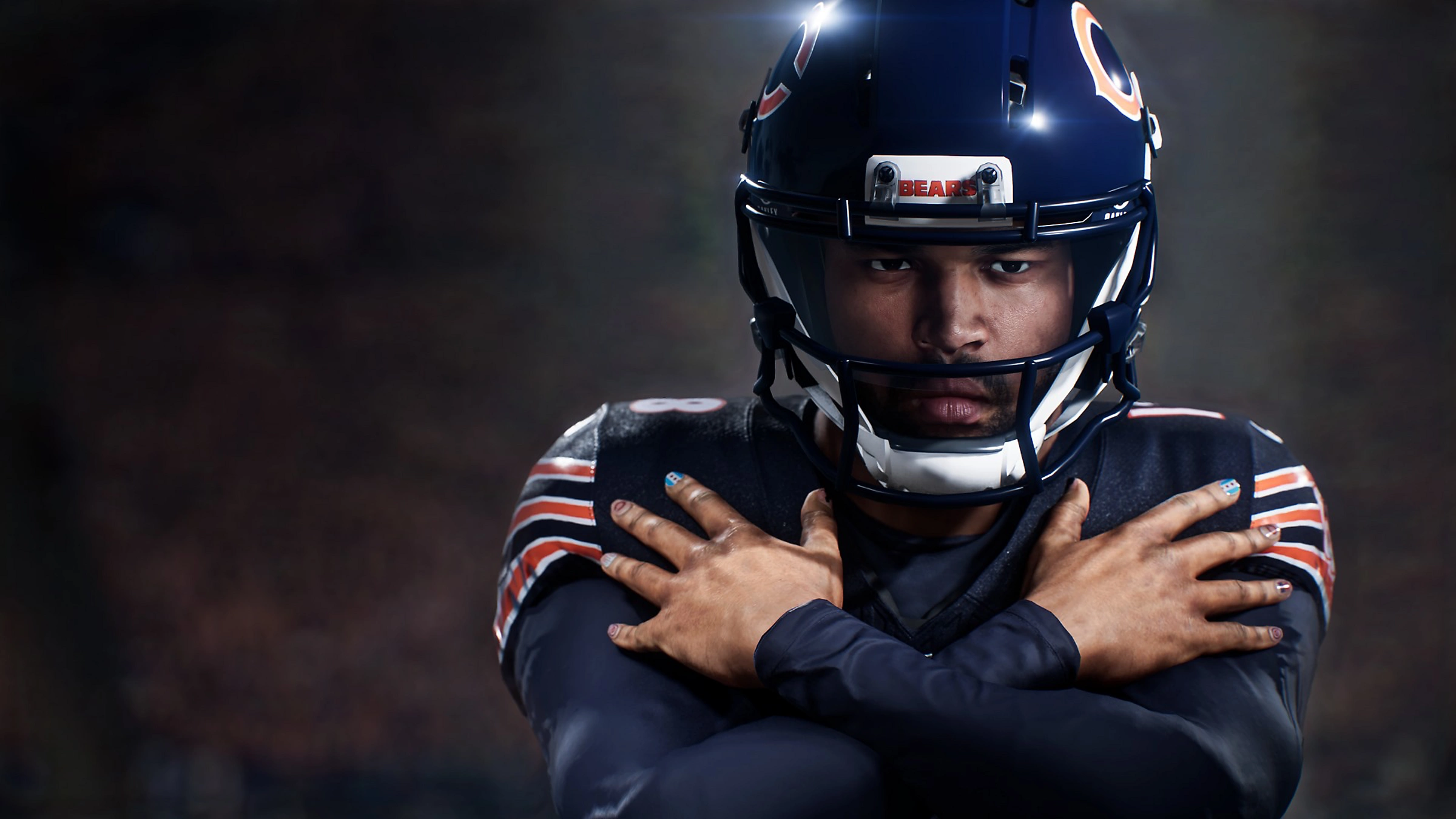 Un giocatore di football americano con casco blu incrocia le braccia sul petto.