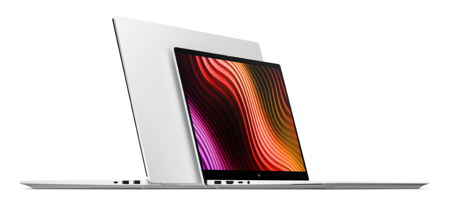 Dwa białe laptopy na czarnym tle. Jeden jest otwarty i ukazuje kolorowy, abstrakcyjny czerwono-pomarańczowy ekran.