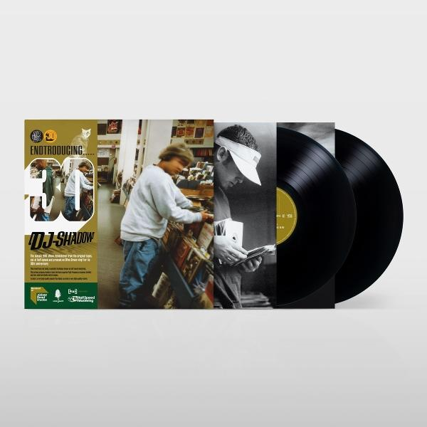 DJ Shadow Vinyl-Albumset mit farbigen Hüllen und zwei schwarzen Schallplatten vor weißem Hintergrund.