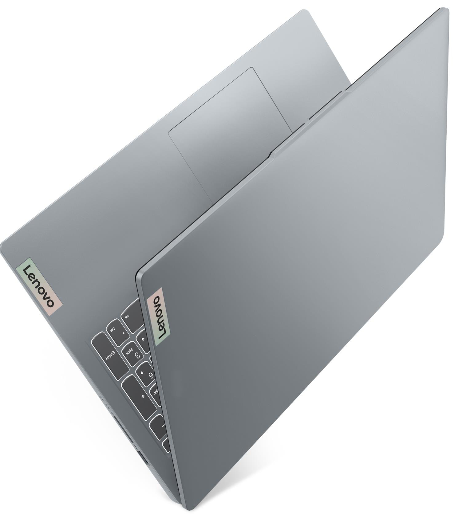 Egy ezüst színű Lenovo laptop félig nyitva áll egy fehér háttéren.