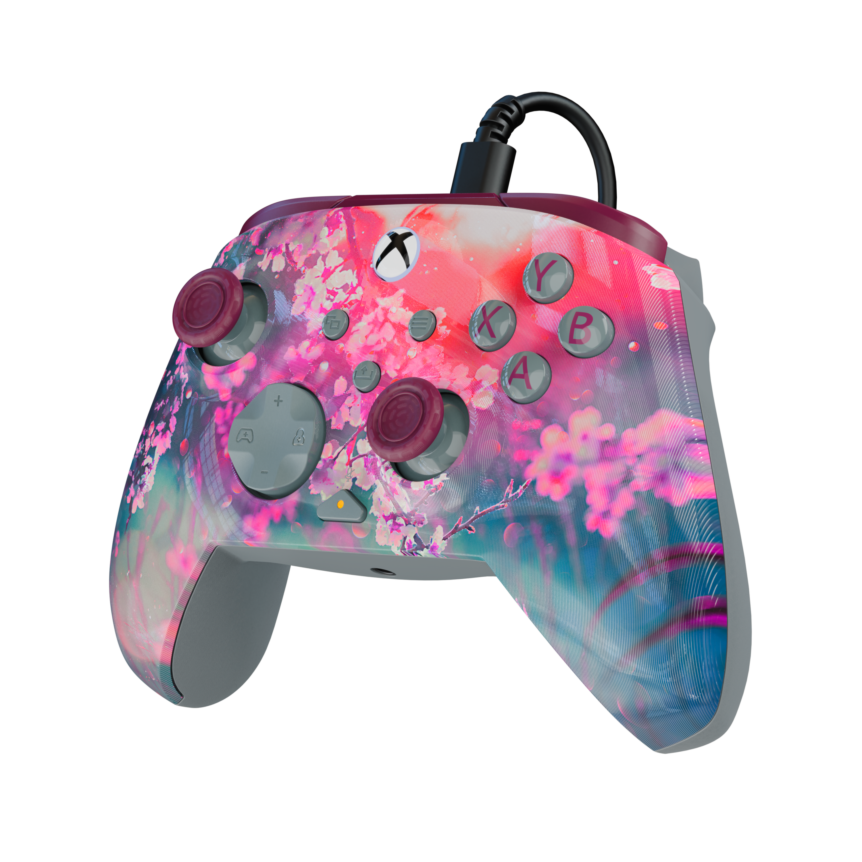 Une manette Xbox avec un motif de fleurs de cerisier roses sur fond noir.