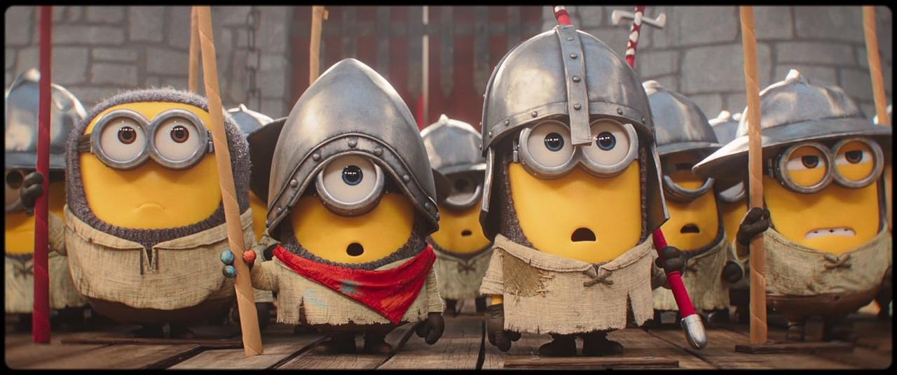 Minions in mittelalterlichen Rüstungen und Tuniken stehen auf Holzplanken vor einer Steinmauer.
