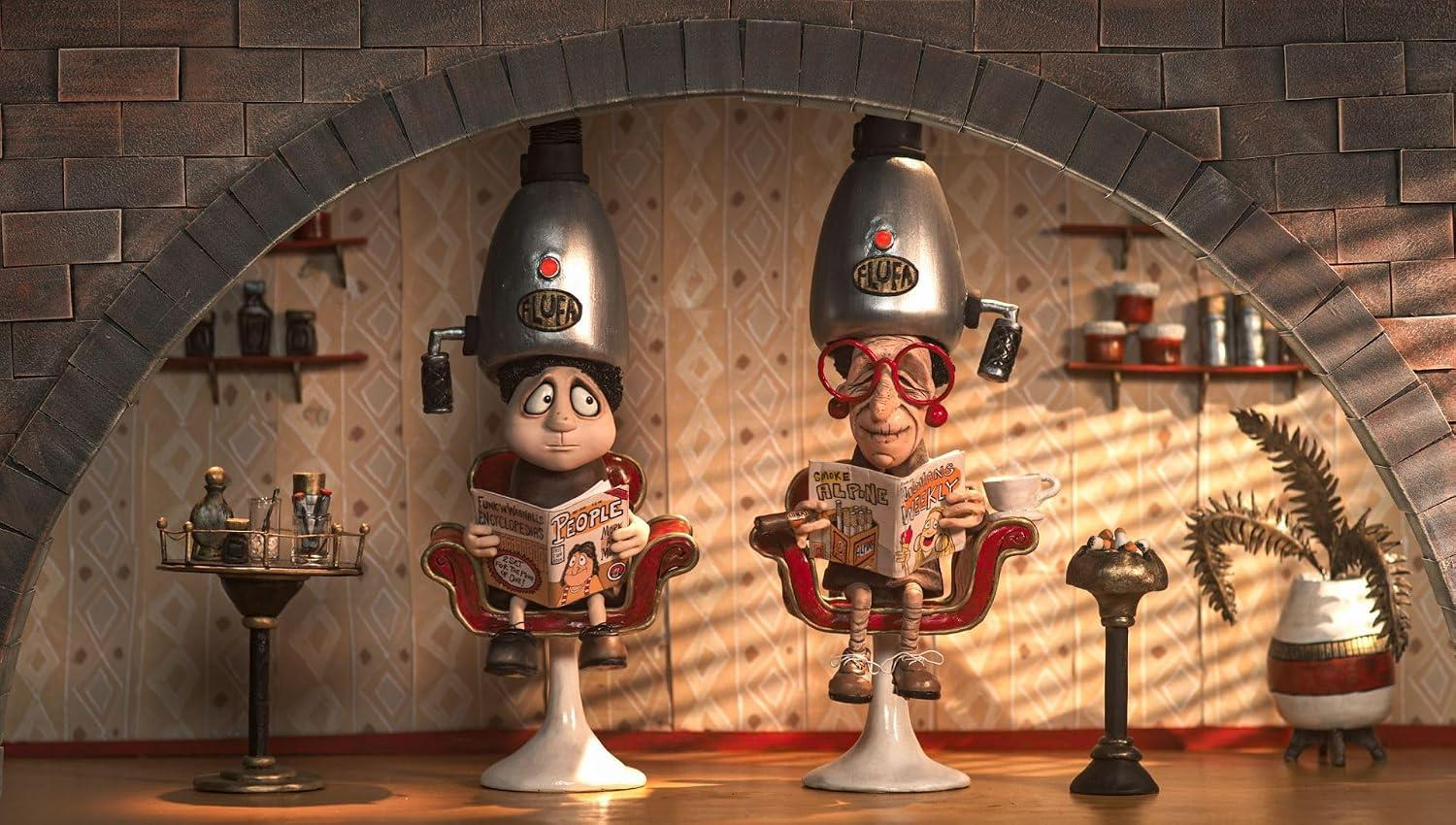 Zwei Puppenfiguren sitzen unter Haartrocknern in roten Stühlen und lesen in einem Ziegelbogenraum.
