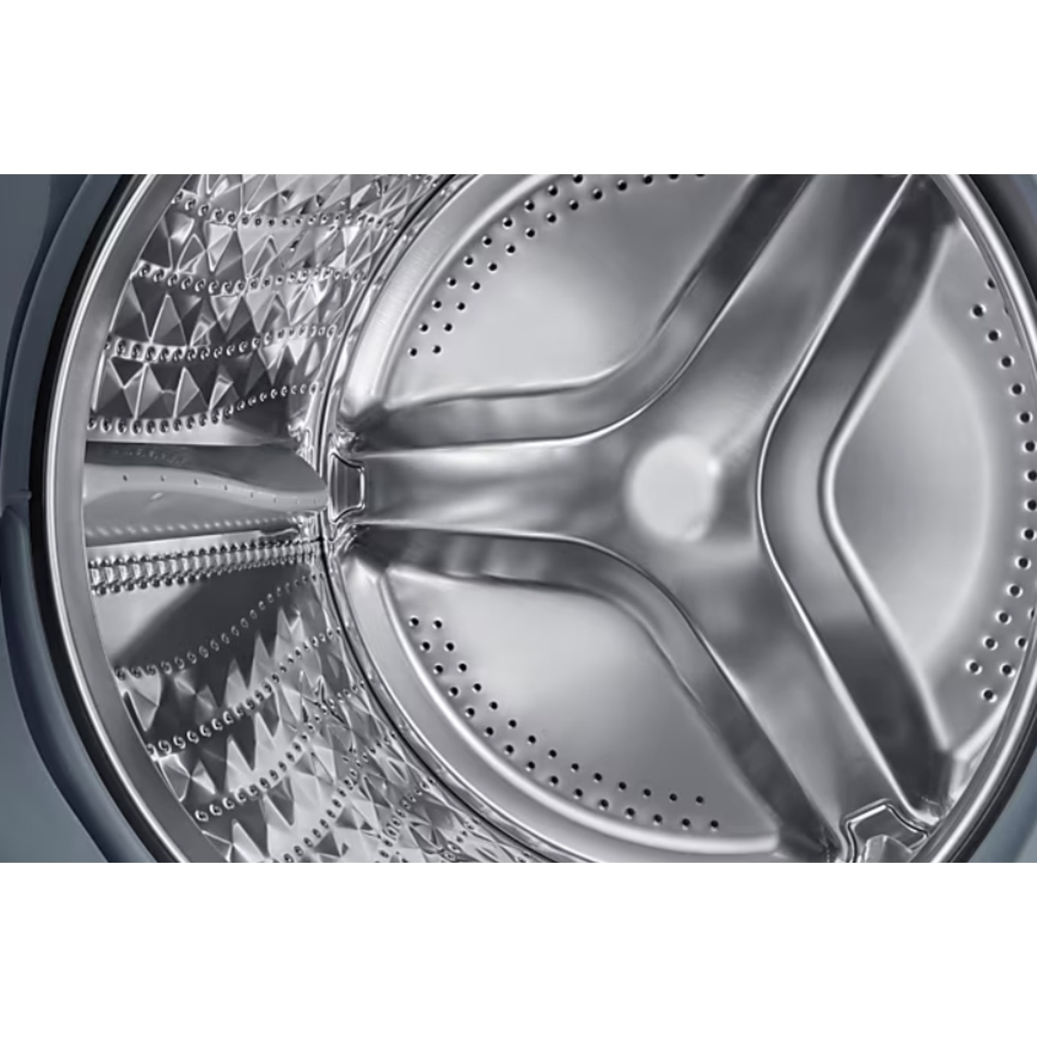 Shiny stainless steel drum of a washing machine with textured pattern and holes.