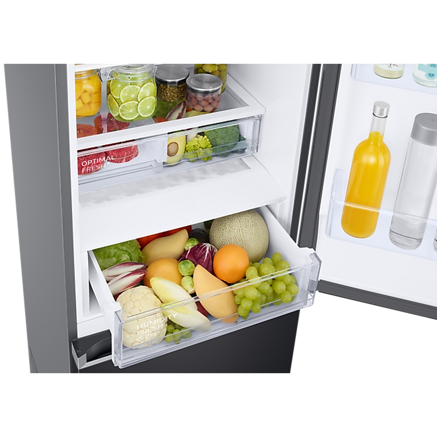 An open refrigerator filled with fresh fruits, vegetables, jars, and beverages.