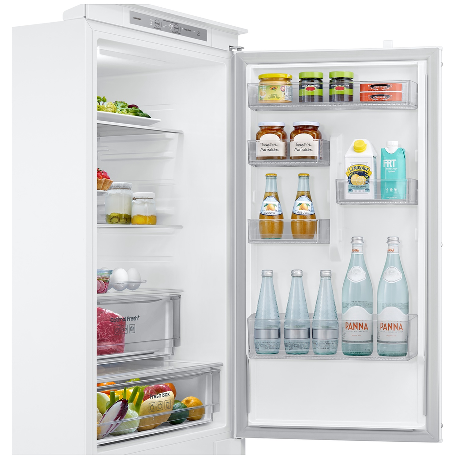 An open white refrigerator stocked with jars, bottles, and fresh food items on shelves and door compartments.