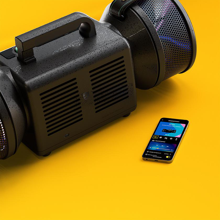 Ein großer, schwarzer Retro-Lautsprecher mit Griff und ein Smartphone mit App auf einer gelben Oberfläche.