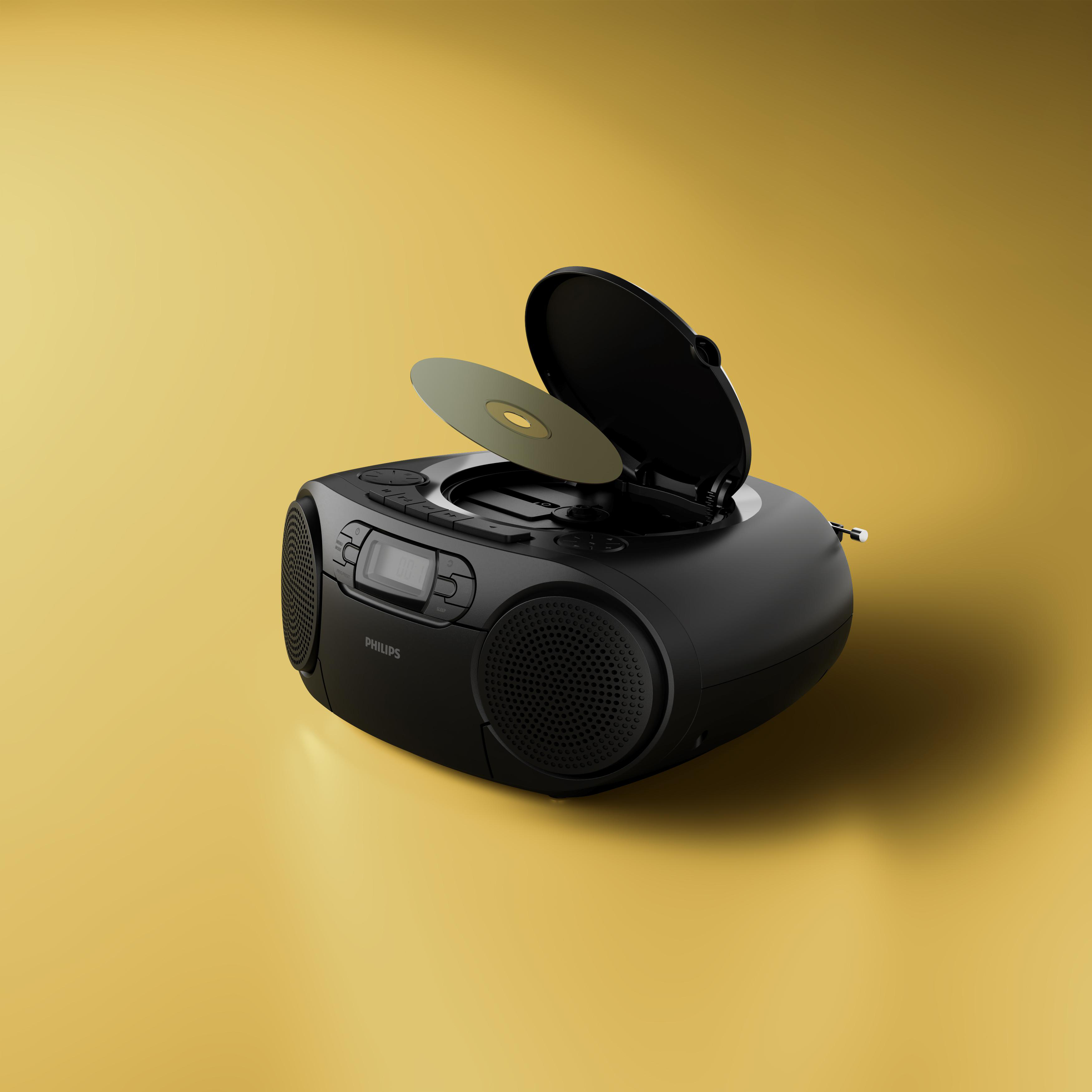 Ein schwarzer tragbarer Philips CD-Player und Radio ist geöffnet mit eingelegter CD vor gelbem Hintergrund.