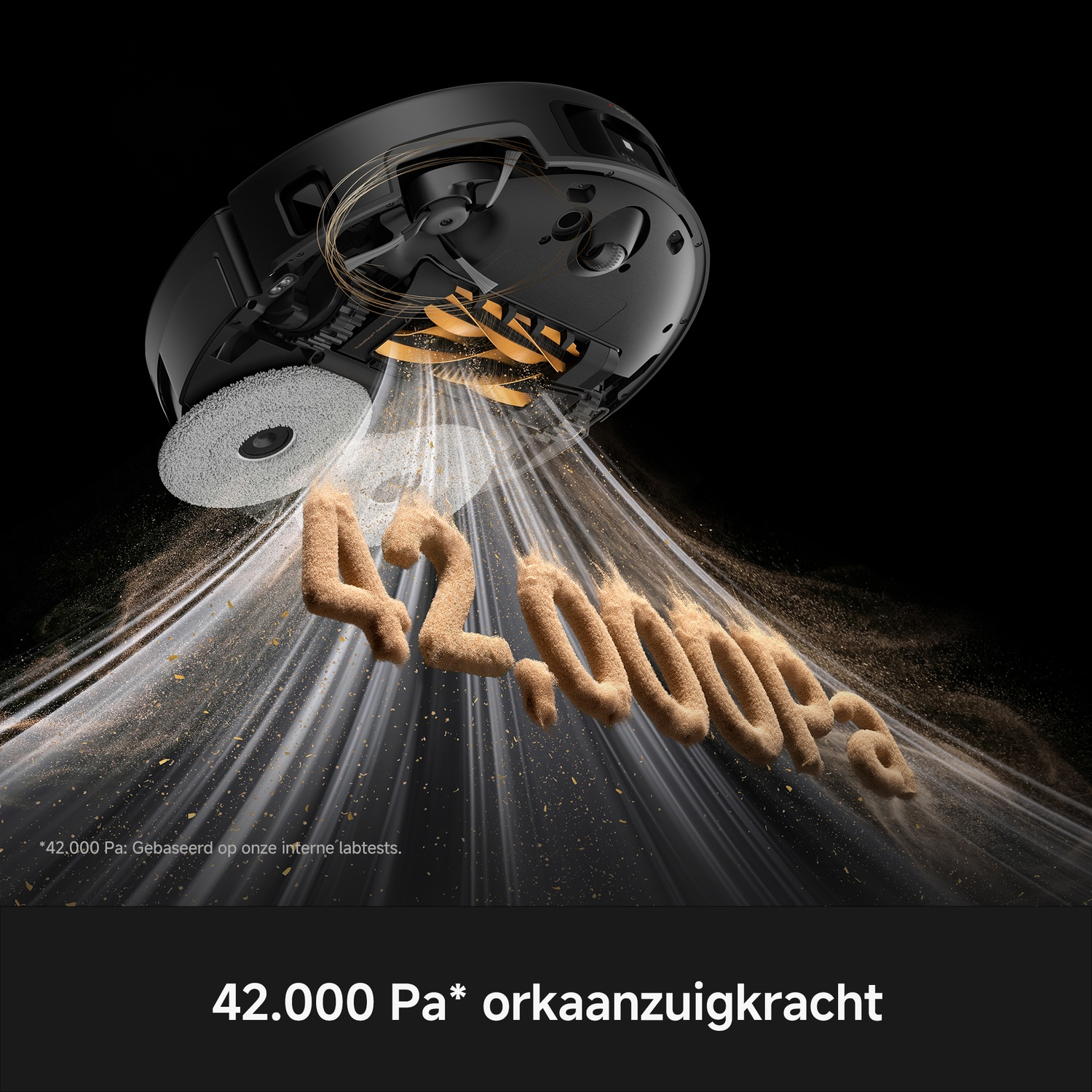 A black robot vacuum cleaner sucking up sand dust forming the text 42,000 Pa, with a dark background.