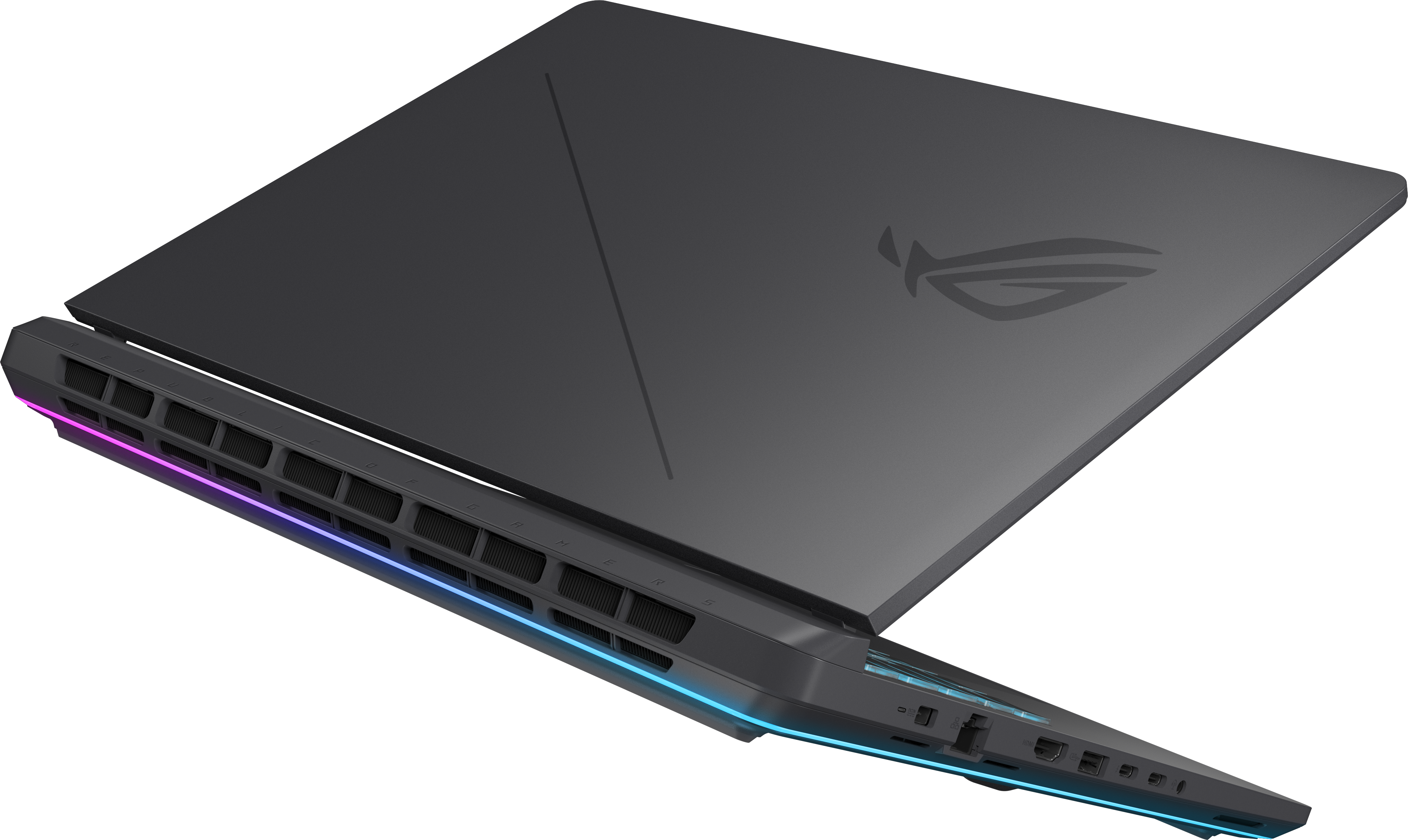Egy szürke gamer laptop zárt fedéllel és RGB világítással a szellőzőnyílásokon, fekete háttér előtt.