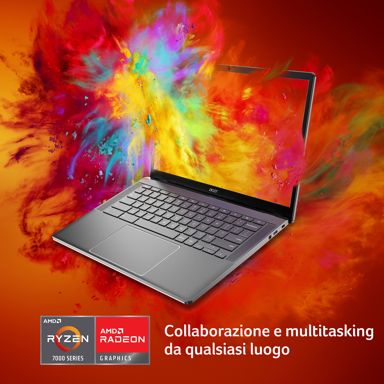 Un laptop argento su uno sfondo di polveri colorate in esplosione.