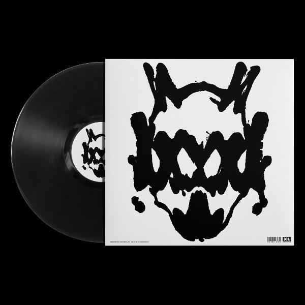Schwarze Vinylplatte neben einem weißen Cover mit einem abstrakten, tintenklecksartigen schwarzen Motiv auf schwarzem Grund.