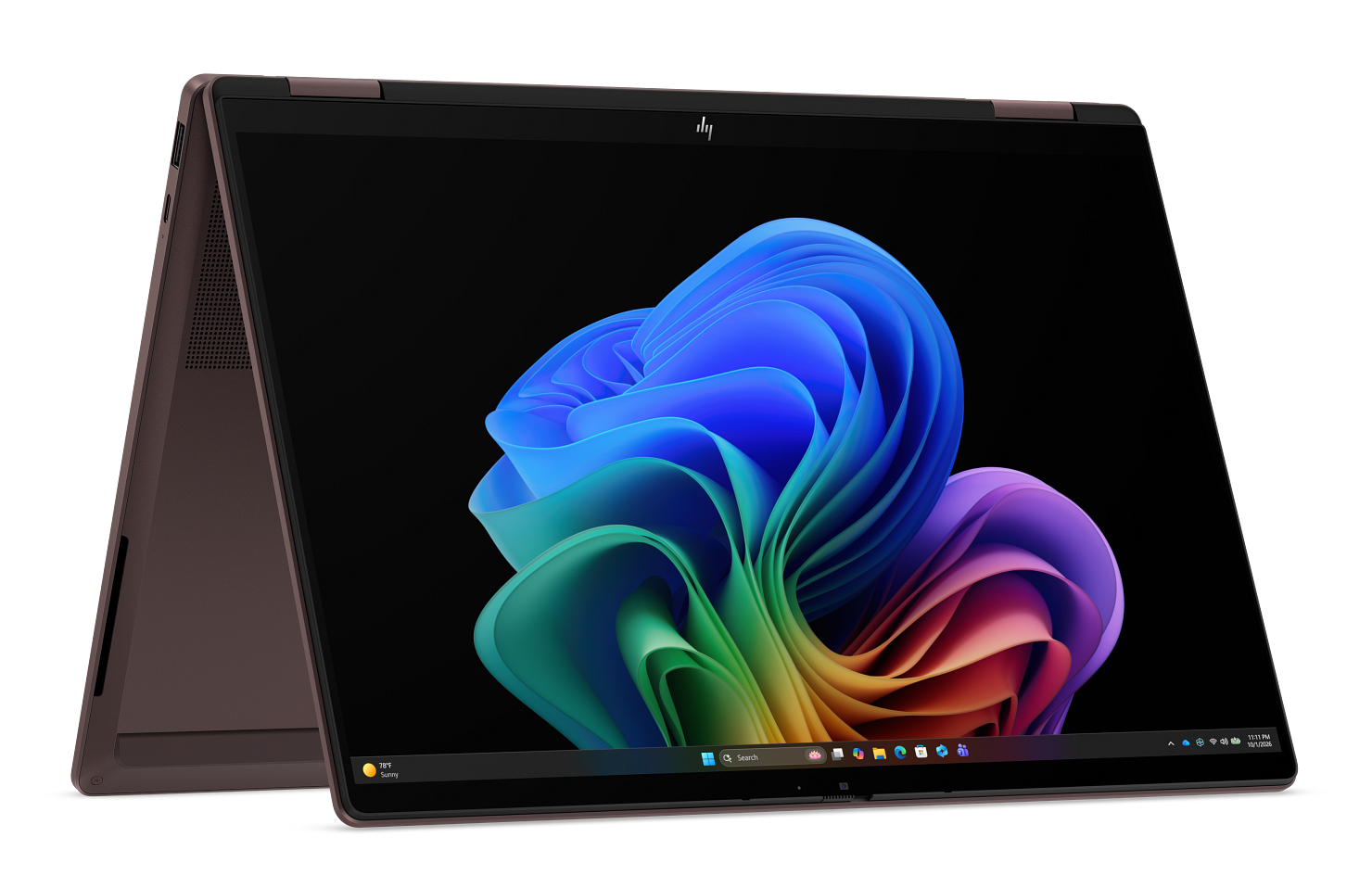 Zamknięty różowy laptop z kolorową, abstrakcyjną tapetą Windowsa na czarnym tle.