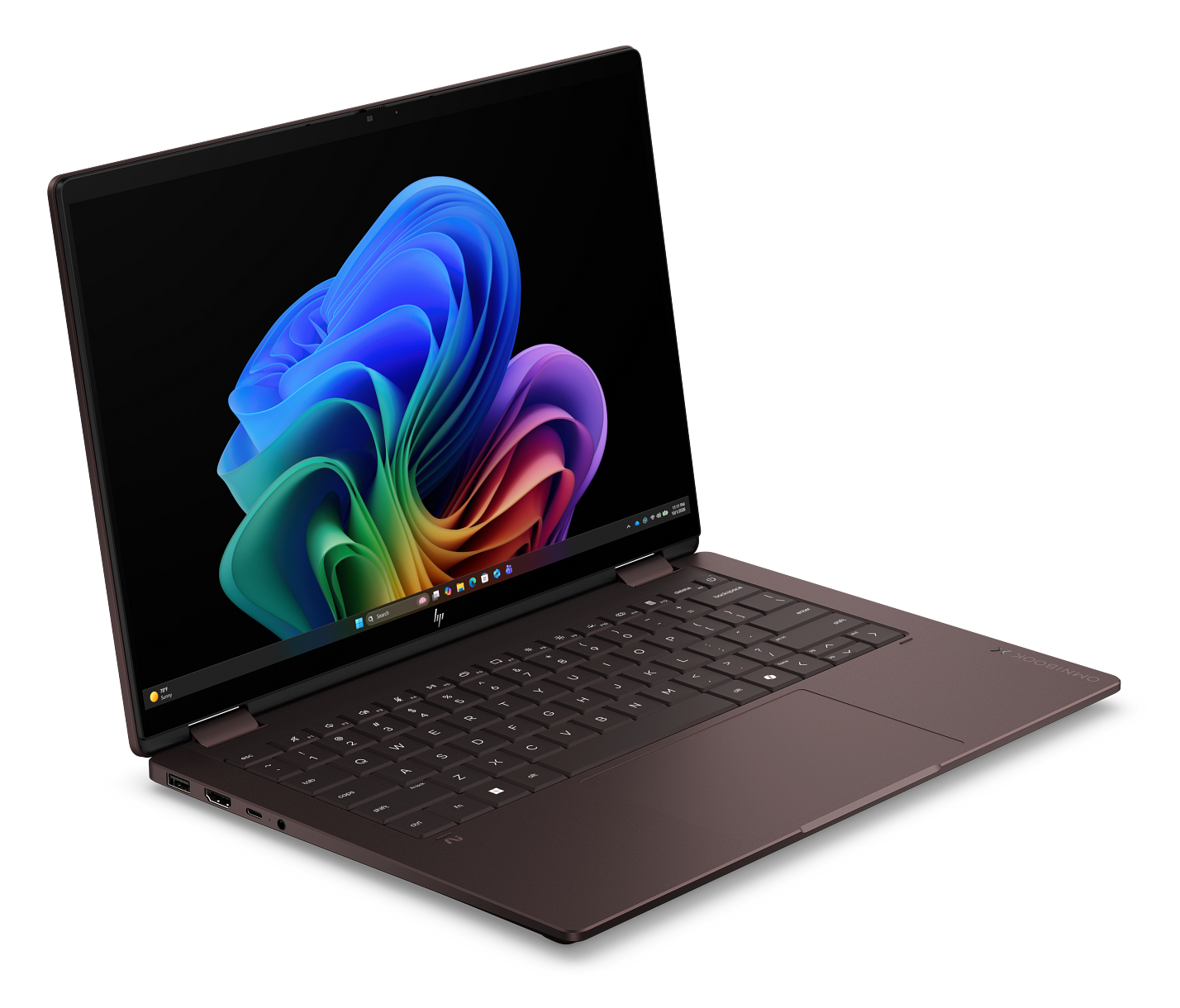 Laptop w kolorze różowego złota z podświetlanym ekranem na czarnym tle.