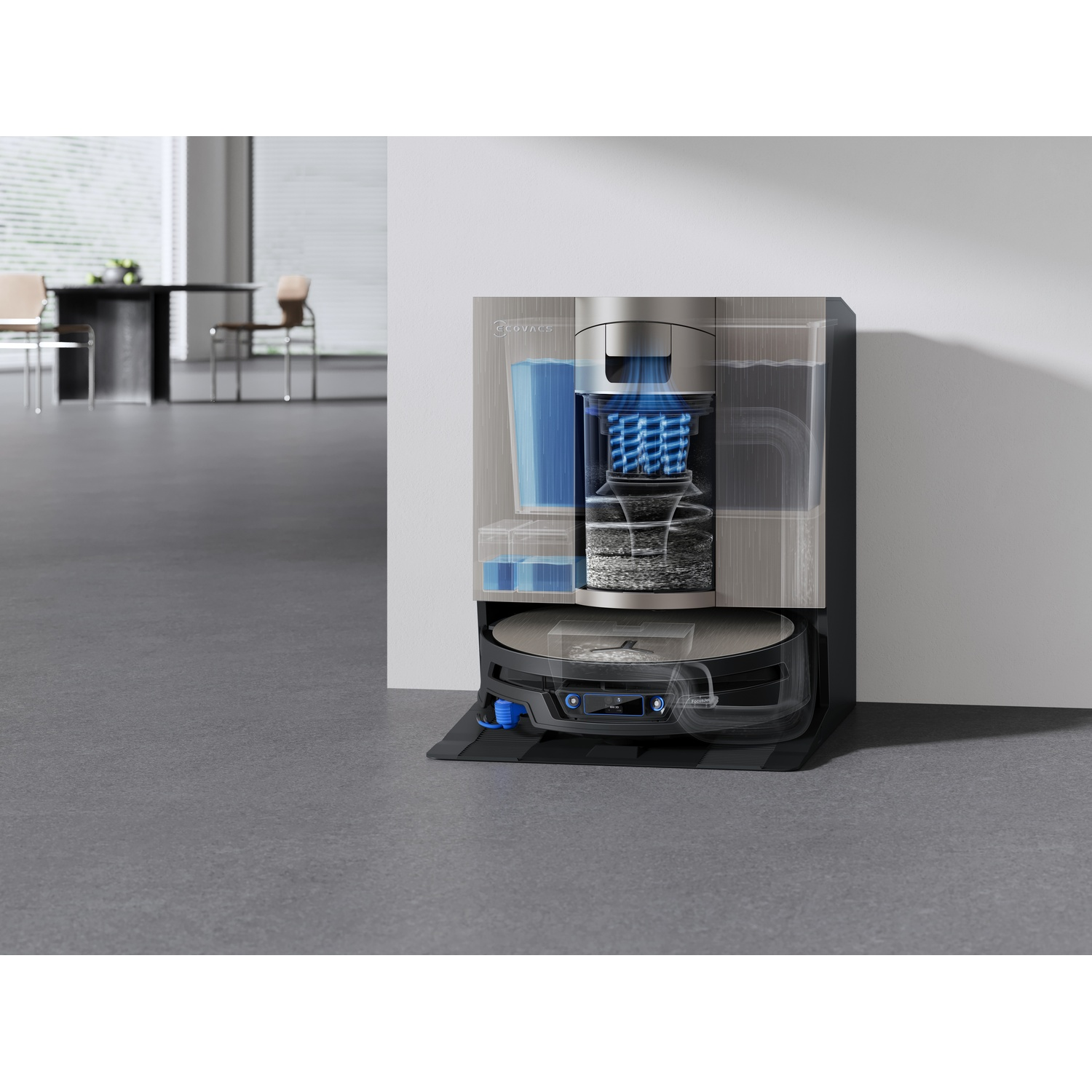 Sezione di una base per robot aspirapolvere con serbatoi d'acqua e filtri, e robot collegato in una stanza.