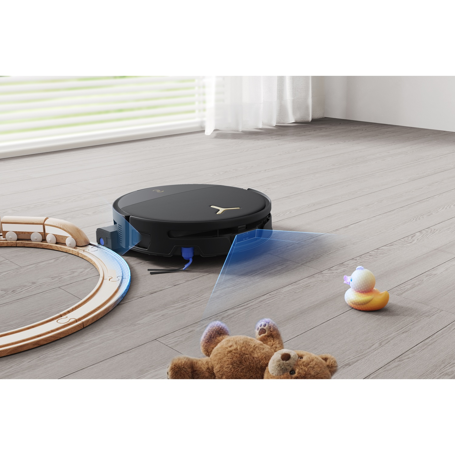 Un robot aspirapolvere nero scansiona giocattoli di legno e un peluche con raggi di luce blu.