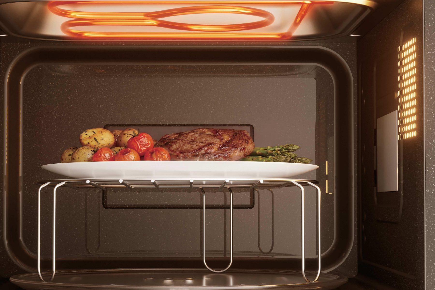 Un plato de carne, tomates, patatas y espárragos se cocina en una rejilla dentro de un horno iluminado.
