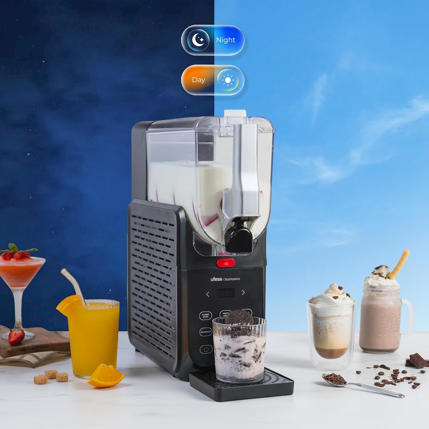 Una macchina per granite su un tavolo circondata da frullati, succhi e cioccolato su sfondo giorno e notte.