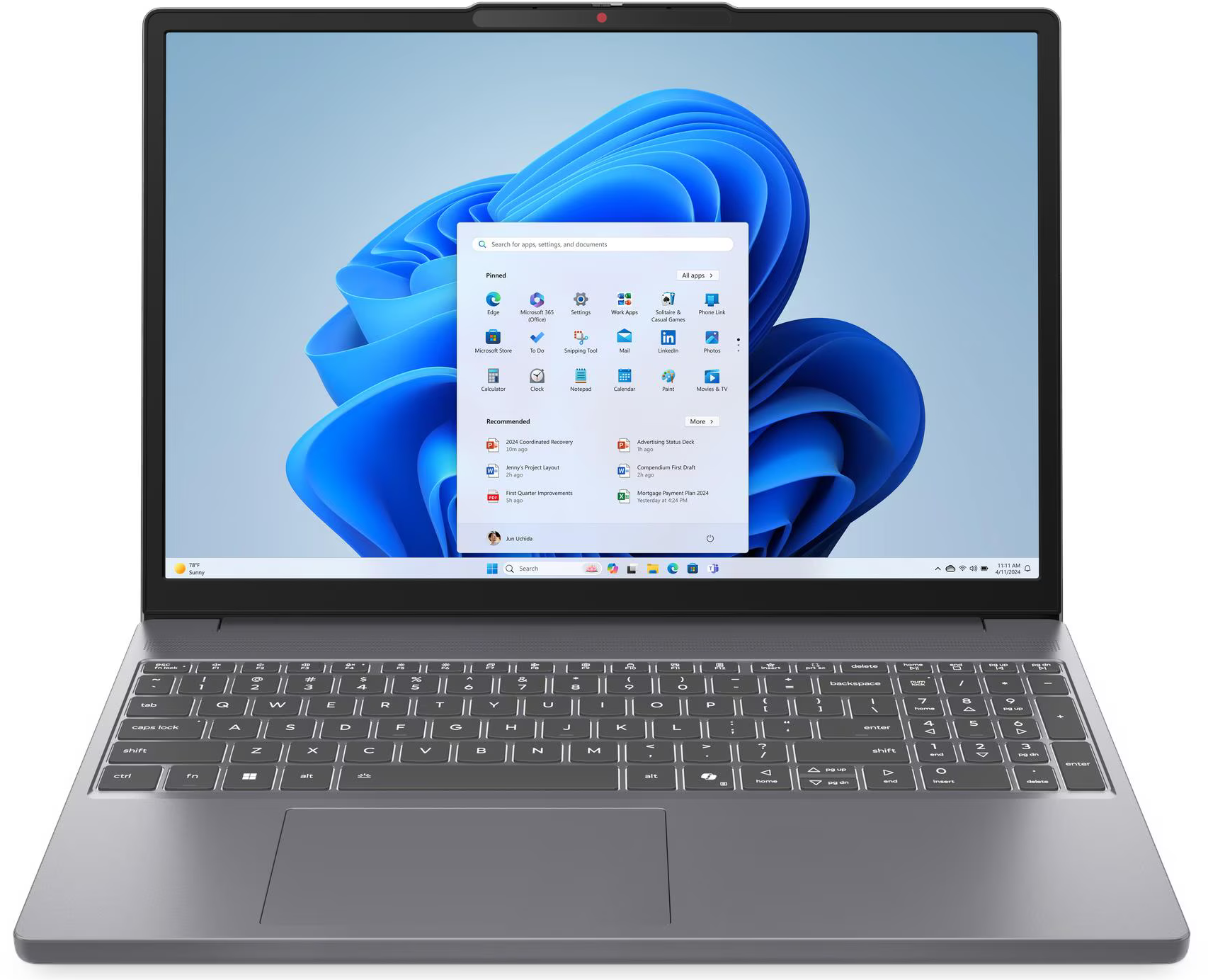 Egy szürke laptop Windows 11 Start menüvel a képernyőjén és teljes billentyűzettel.
