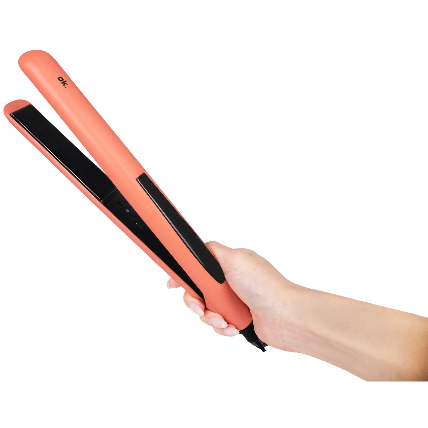 A hand holds a peach-colored hair straightener with black plates against a white background.