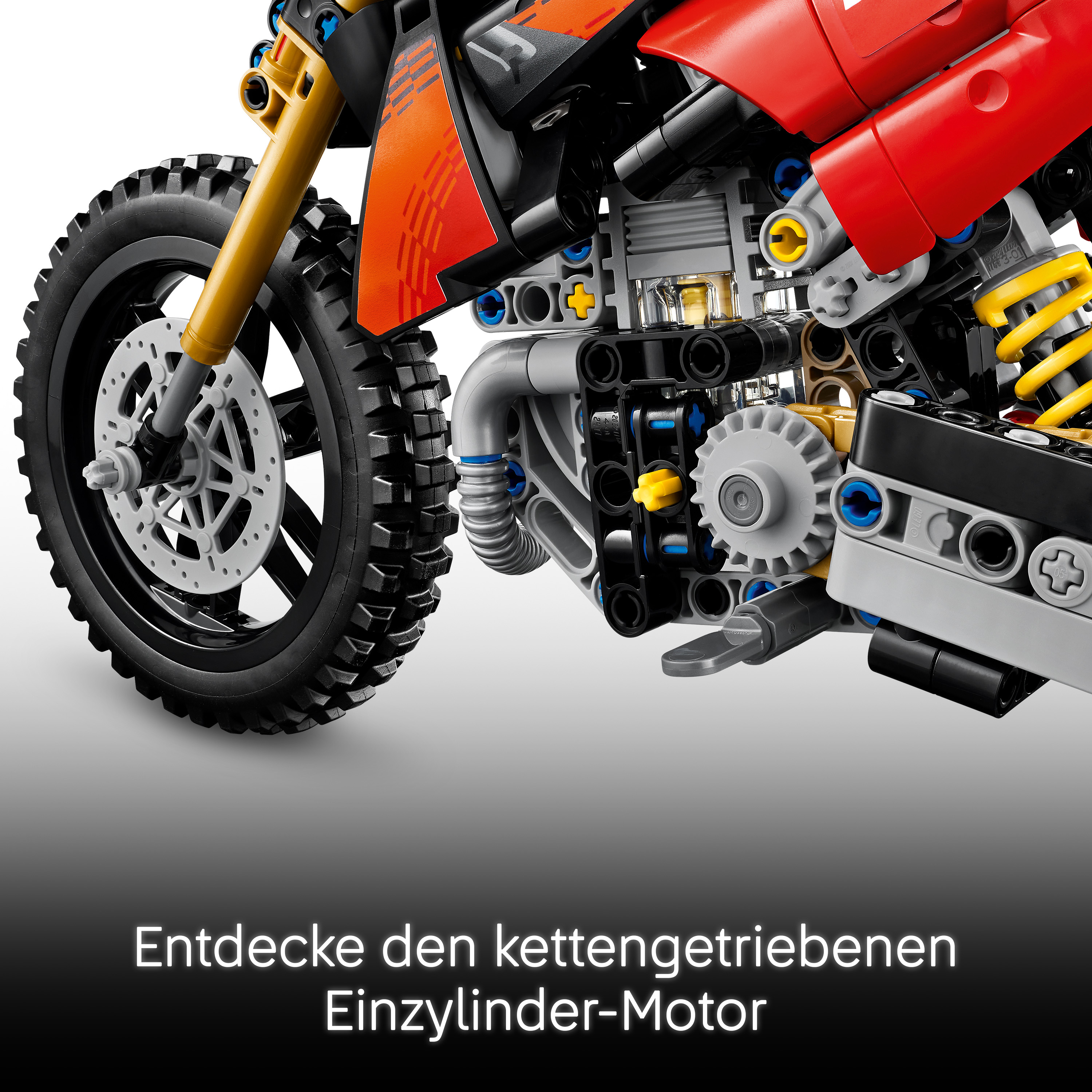 Detailansicht eines roten Lego Technic Motorrads mit Vorderreifen und komplexem Motorblock.