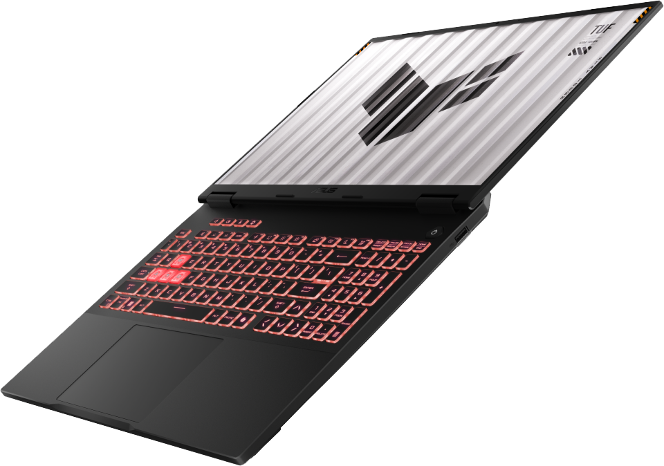 Fekete laptop piros háttérvilágítású billentyűkkel és geometriai mintás képernyővel, fekete háttér előtt.
