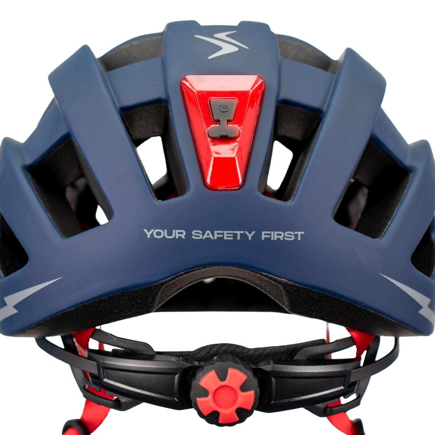 Casco de bicicleta azul visto desde atrás con luz roja y texto 'YOUR SAFETY FIRST'.