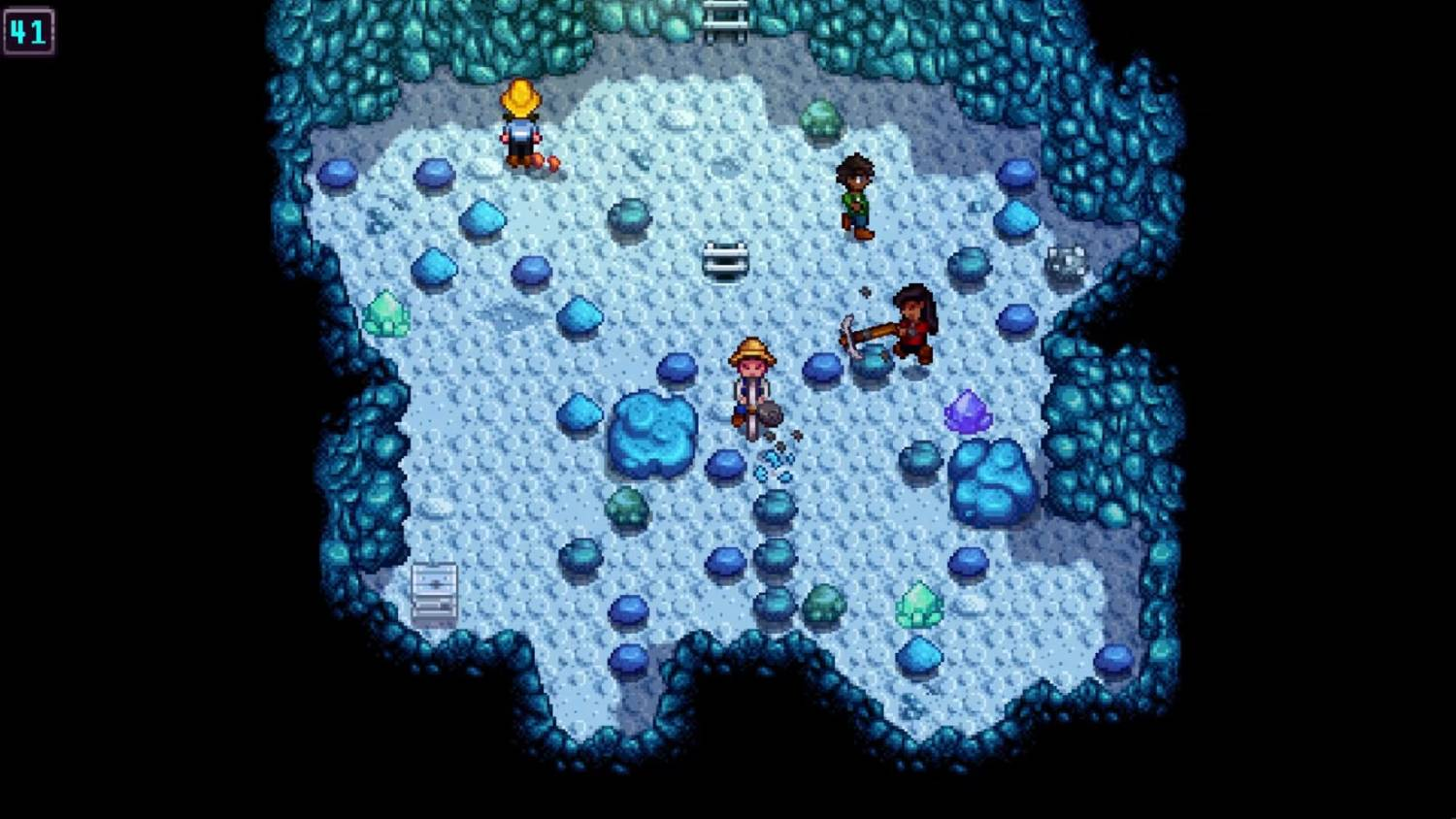 Cuatro personajes en una cueva helada y azulada llena de minerales y rocas.