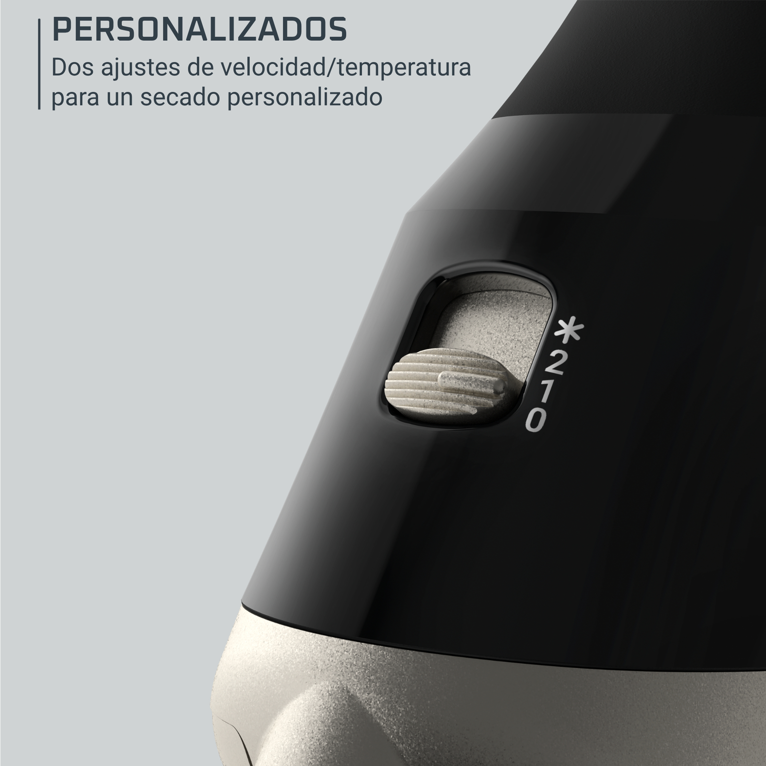 Primer plano de un secador negro con un interruptor deslizante plateado con las posiciones 0, 1, 2 y un icono de estrella.
