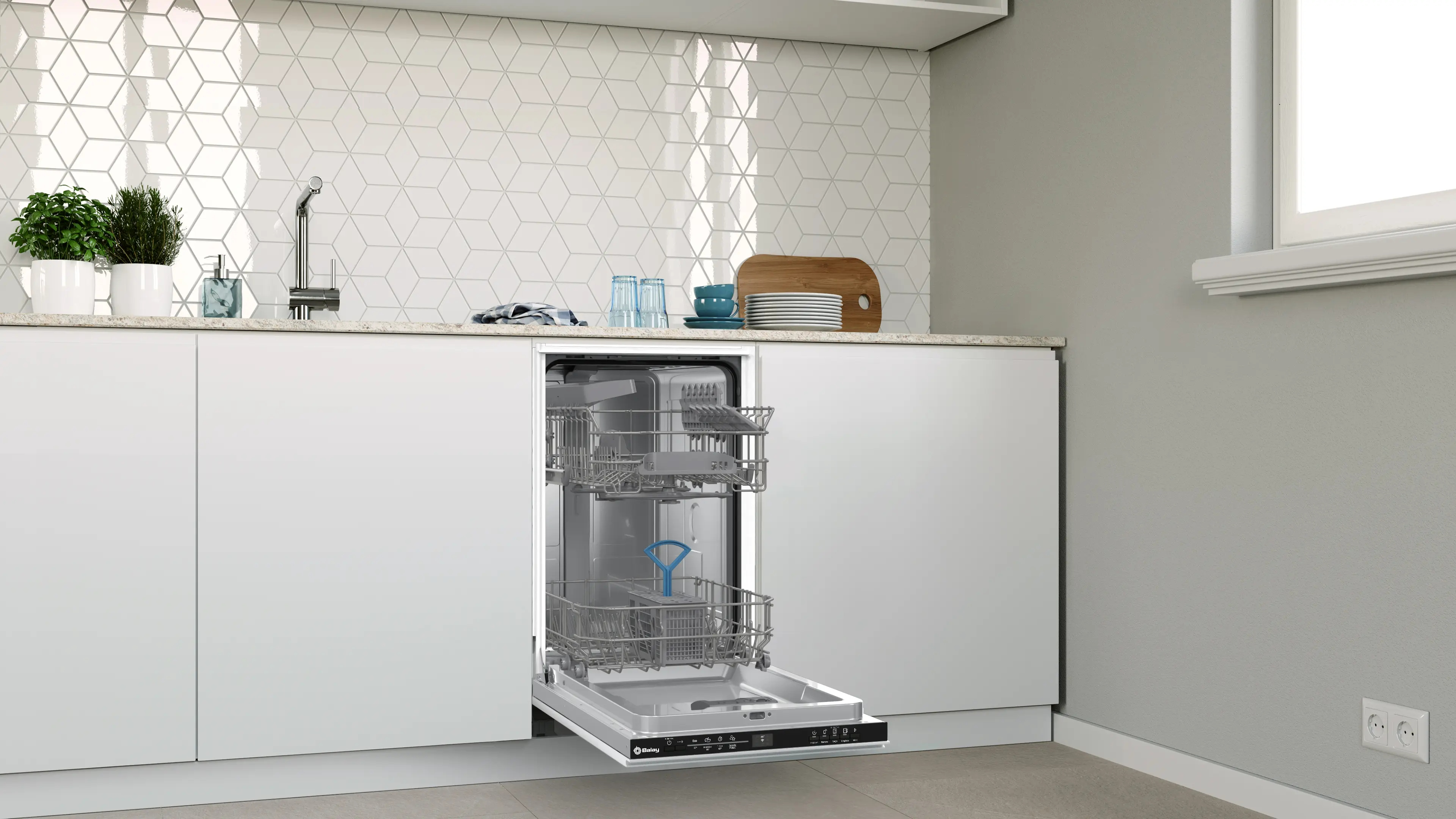 Lavavajillas blanco abierto en una cocina moderna con azulejos geométricos.