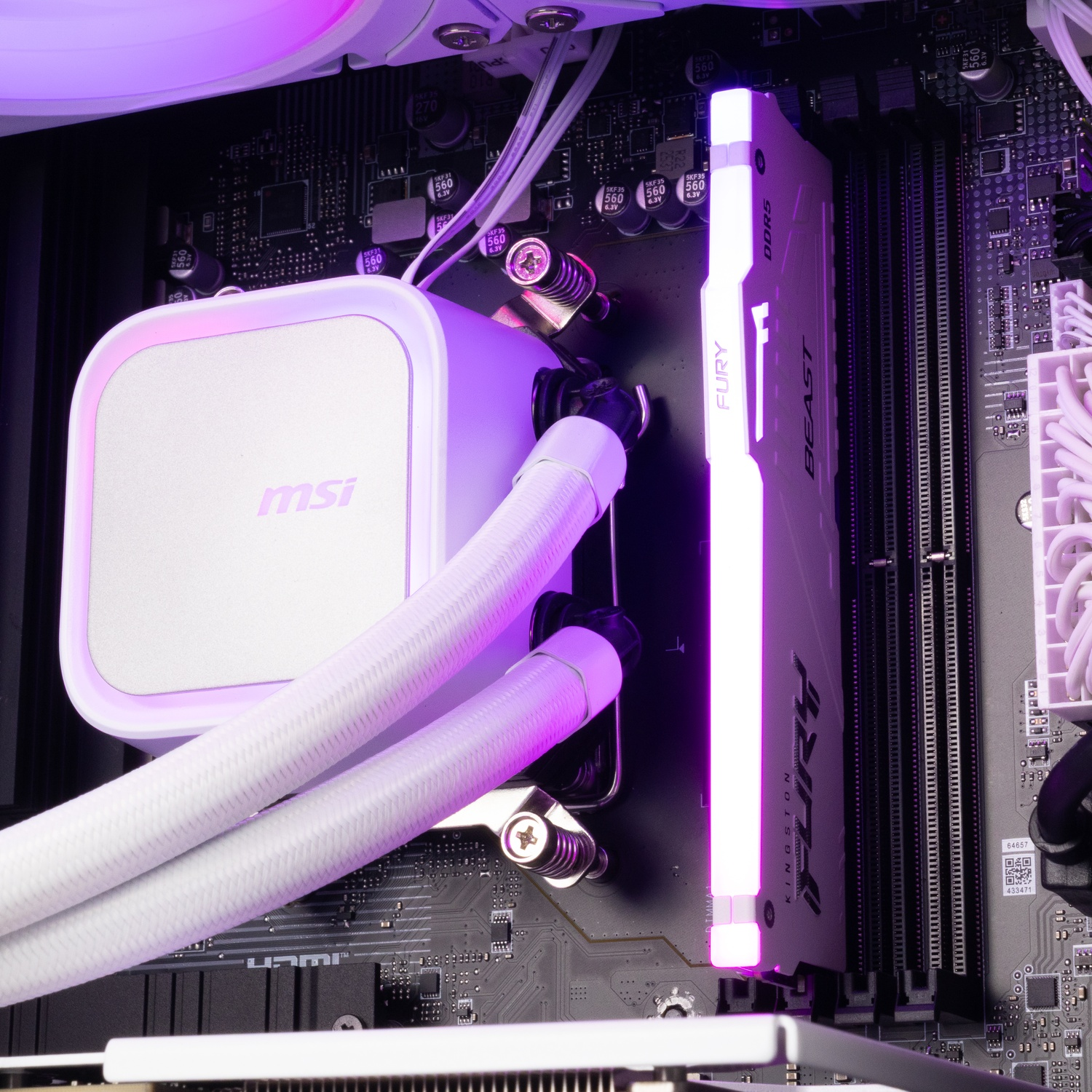 Inside of a PC with a white MSI liquid cooler block, white braided tubes, and an illuminated Kingston Fury RAM stick.